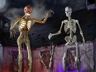 The giant skeleton decorations from Home Depot on a spooky Halloween set