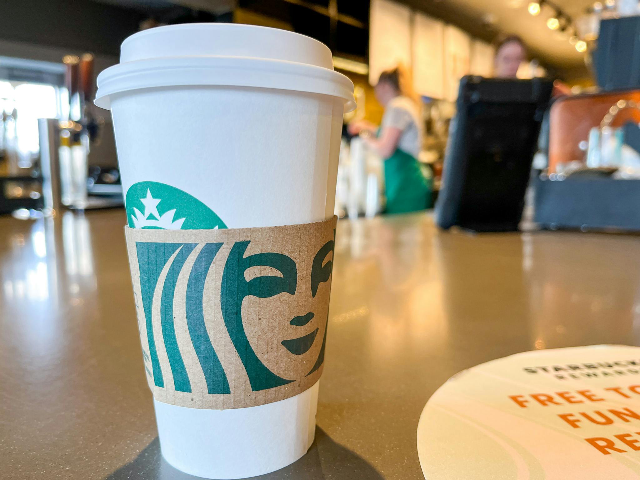 starbucks disposable cup with sleeve on counter