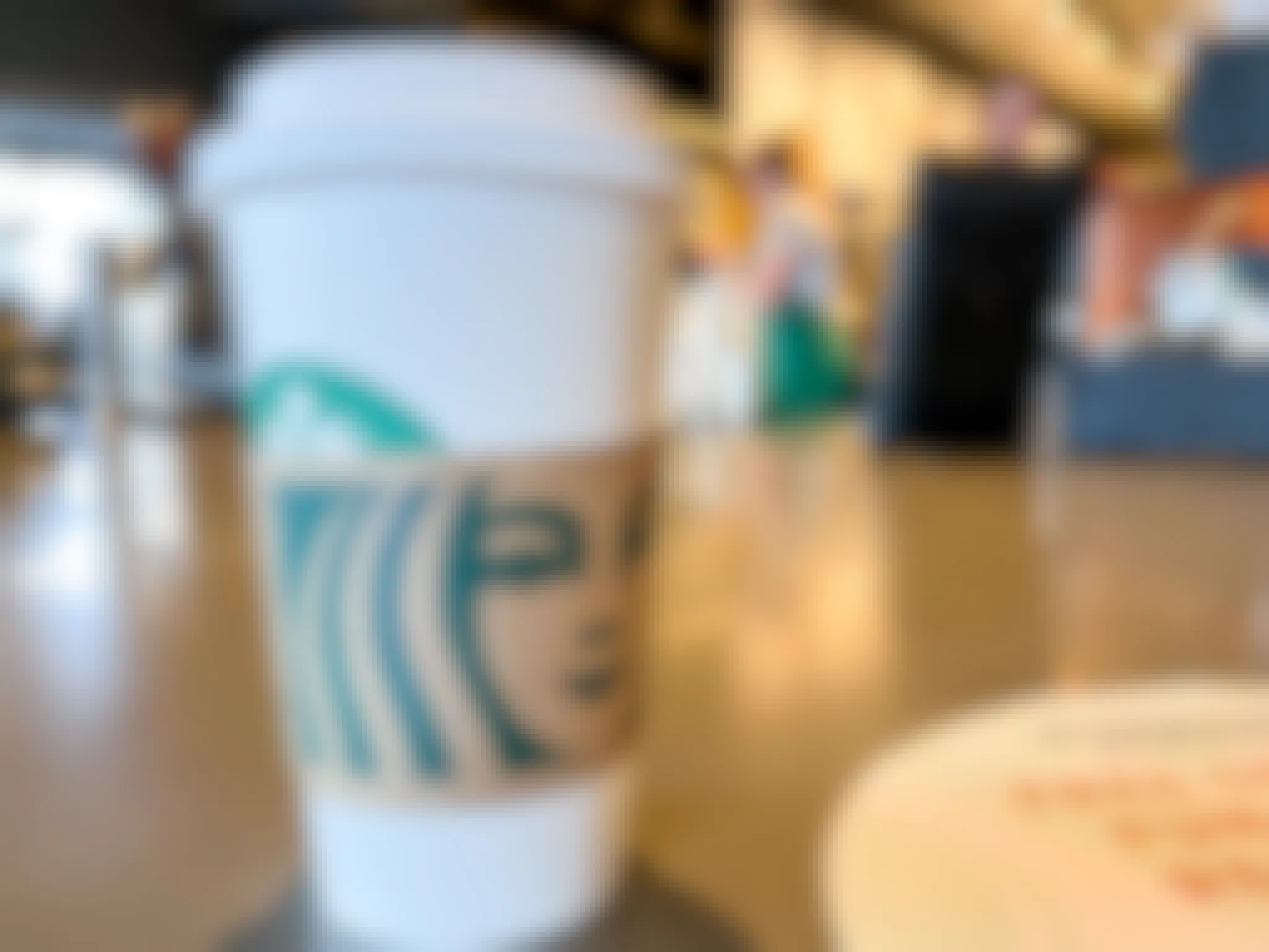 starbucks disposable cup with sleeve on counter
