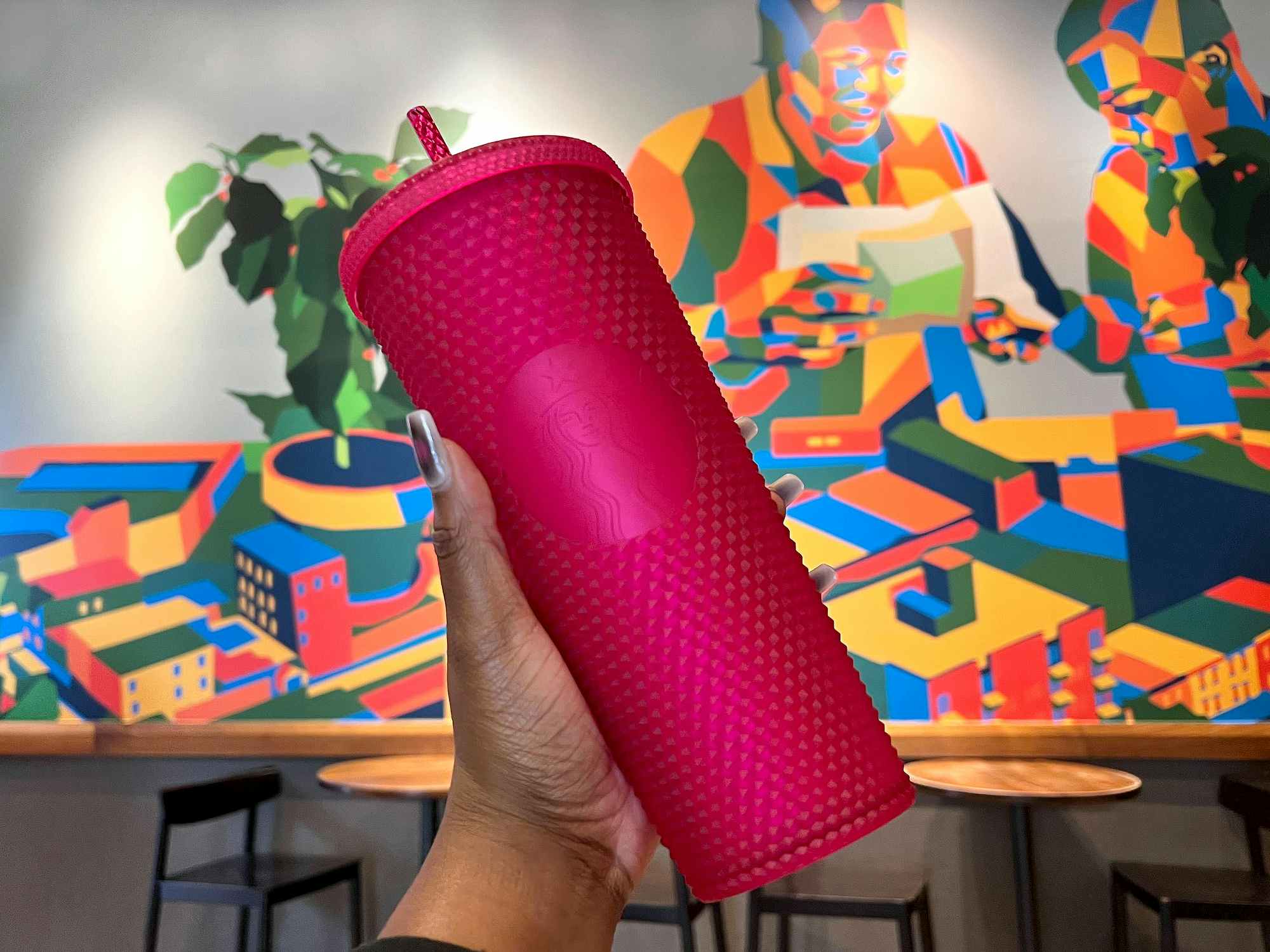 hand holding the spring 2023 ruby bling cold cup tumbler in starbucks restaurant