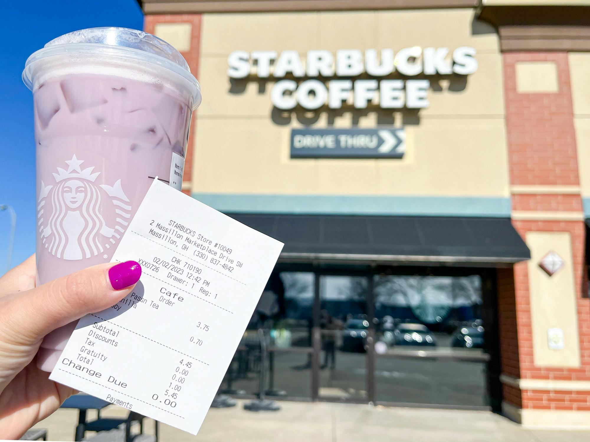 starbucks taylor swift lavender haze drink in front of the Starbucks sign with receipt 