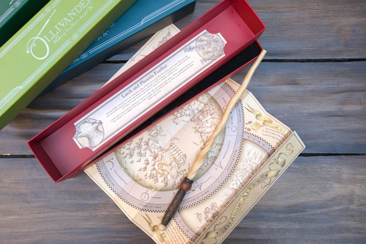harry potter wand on a table with map