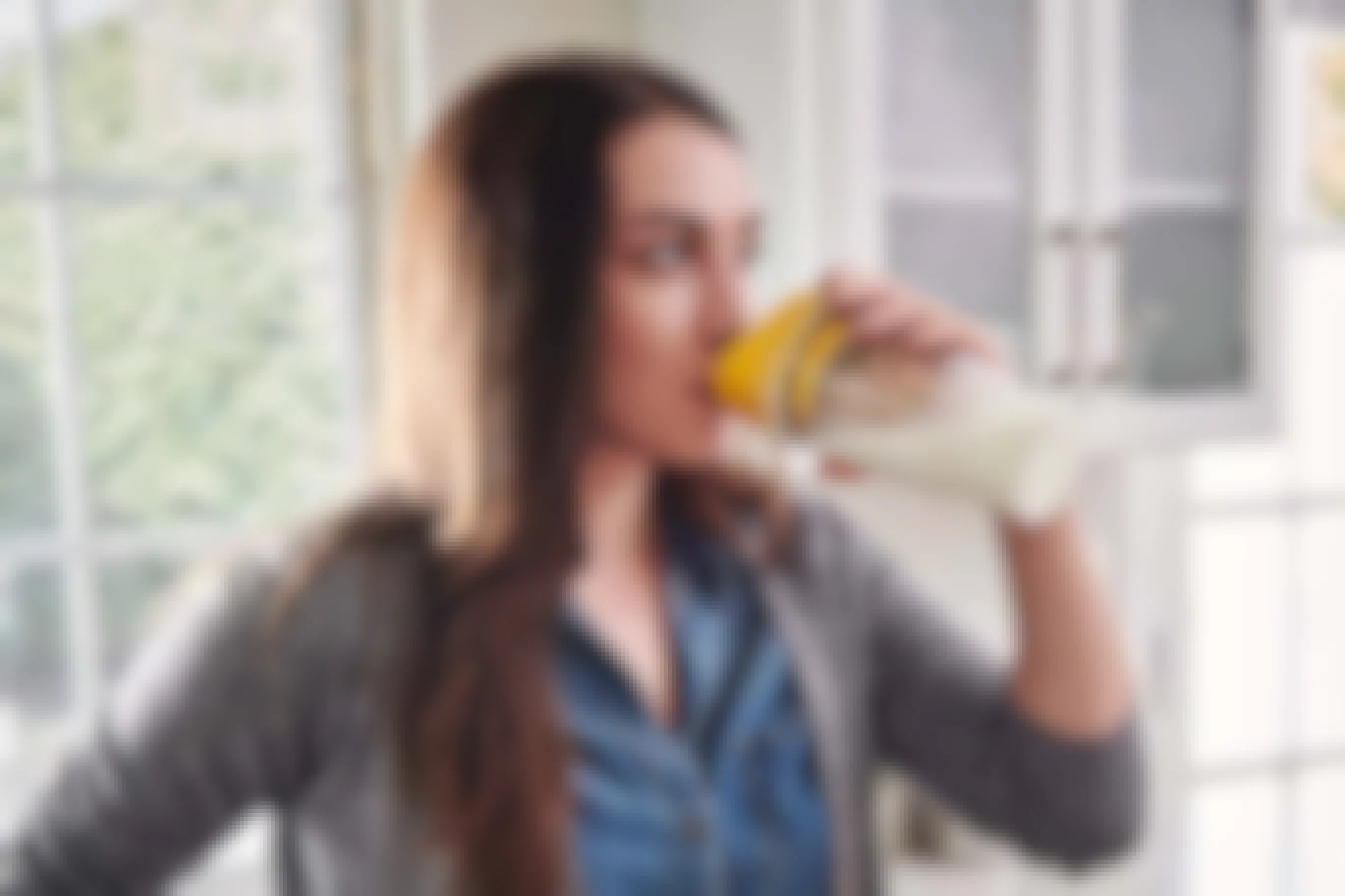 Woman drinking from a yellow crunch cup