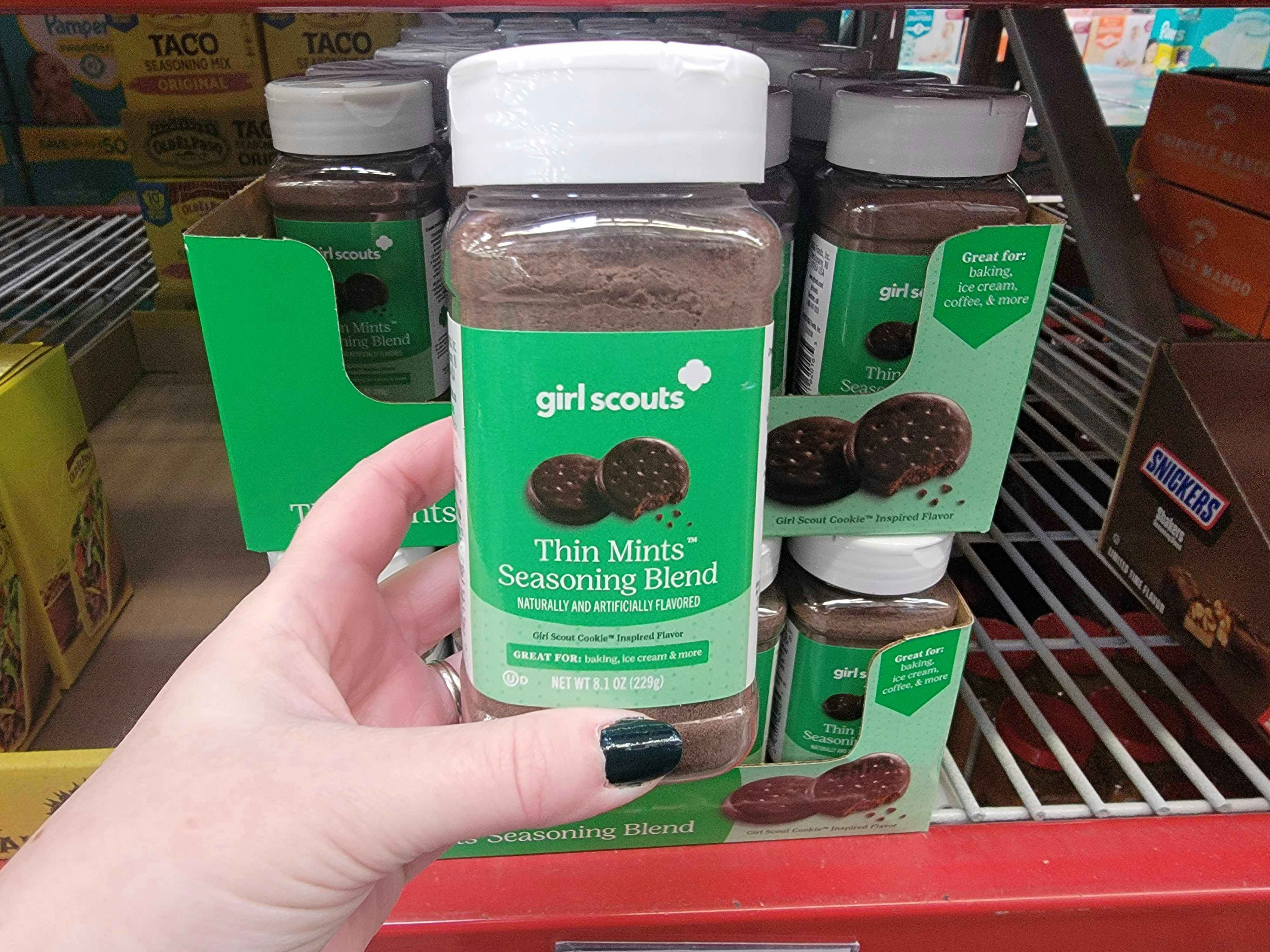 Hand holding girl scout thin mint seasoning inside a Sam's Club