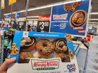 Hand holding Krispy Kreme Donuts