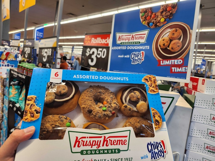 Hand holding Krispy Kreme Donuts