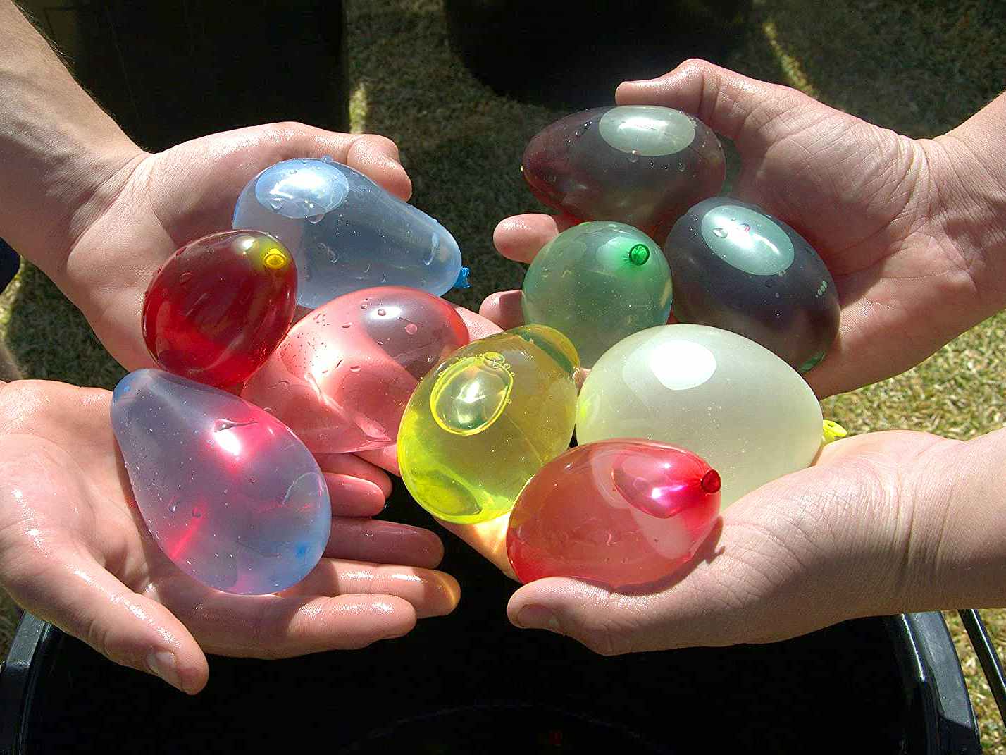 people holding water balloons