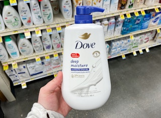 hand holding a jumbo bottle of dove body wash