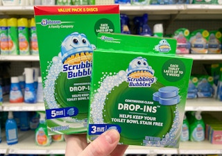 hand holding scrubbing bubbles drop ins