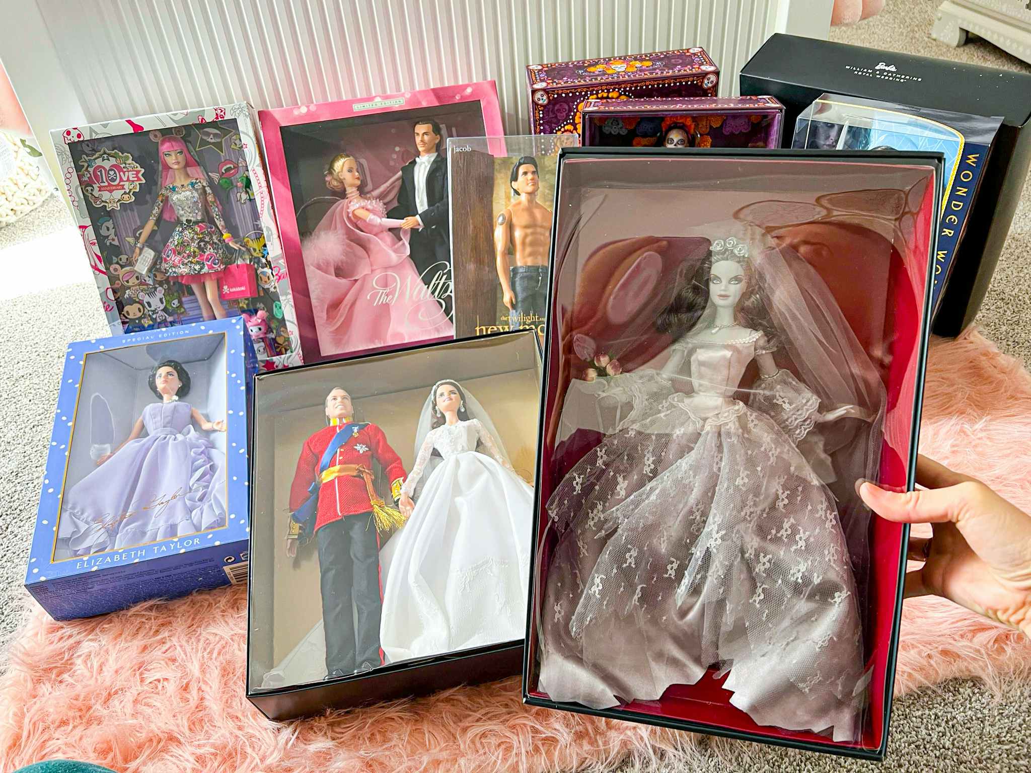 person holding zombie bride barbie with other rare dolls