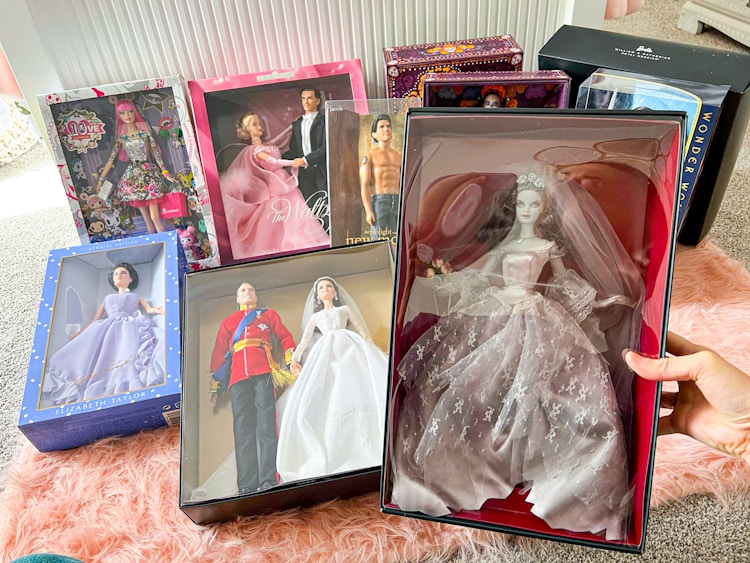 person holding zombie bride barbie with other rare dolls