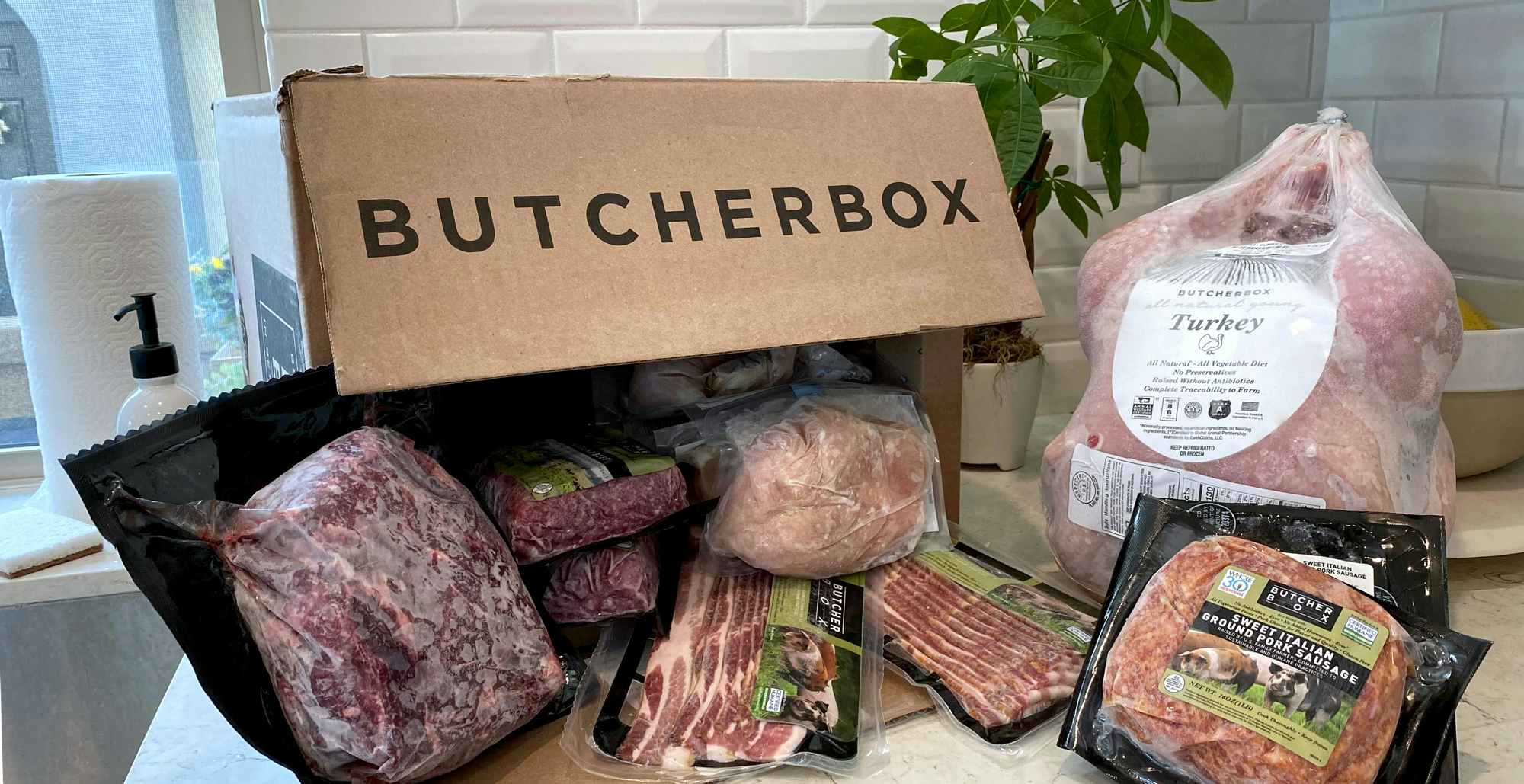 butcherbox delivery box in kitchen with various cuts of meat