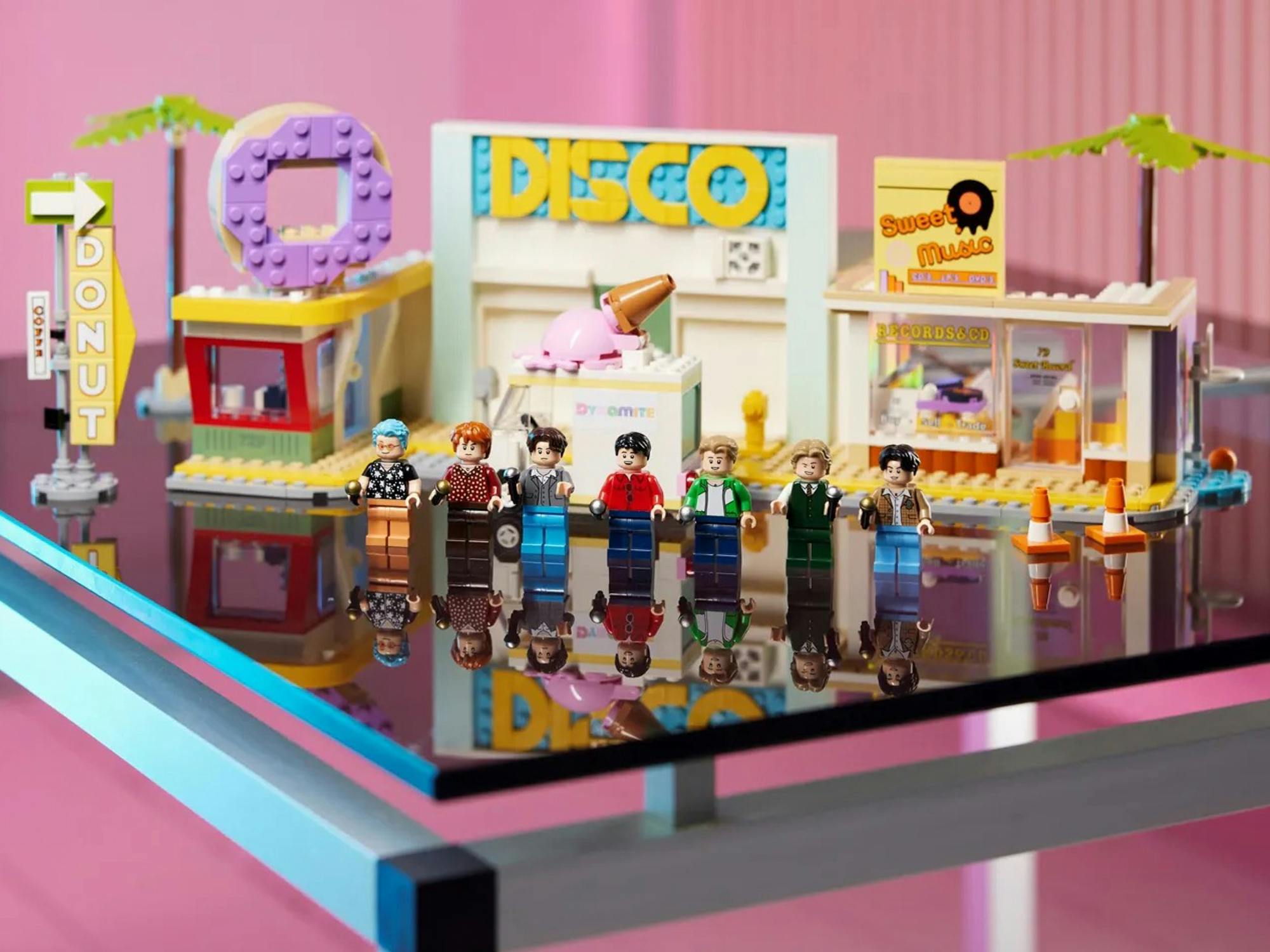 The BTS Dynamite LEGO set with the band members as LEGO People set up on a table