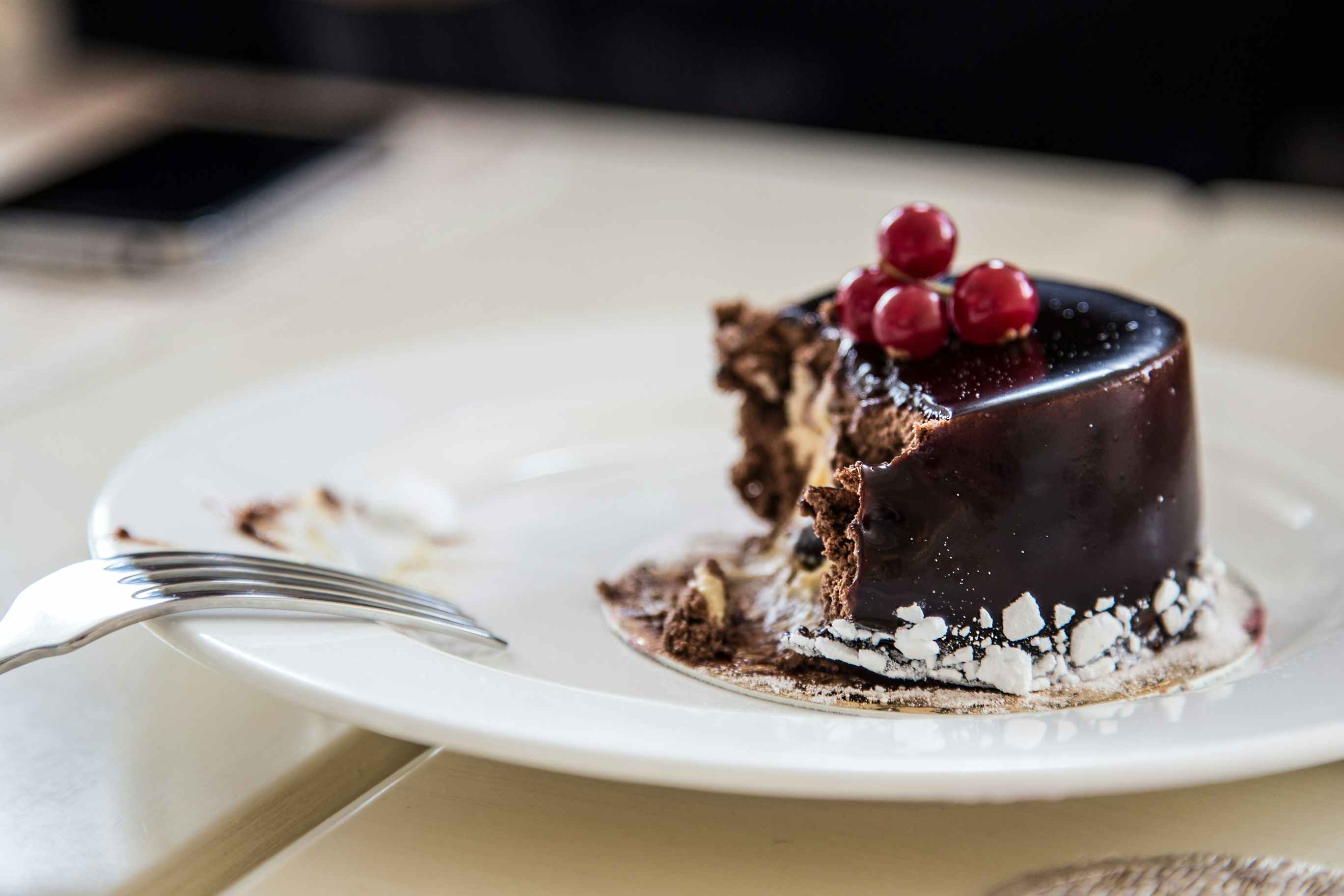 Dark chocolate cake on a plate half eaten