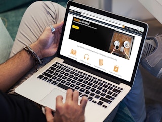 a person looking at the amazon kindle unlimited website on their macbook