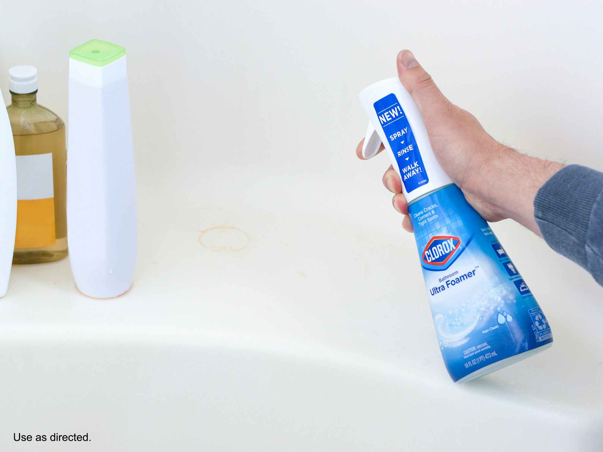 person spraying mildew in bathtub with clorox bathroom ultra foamer cleaner