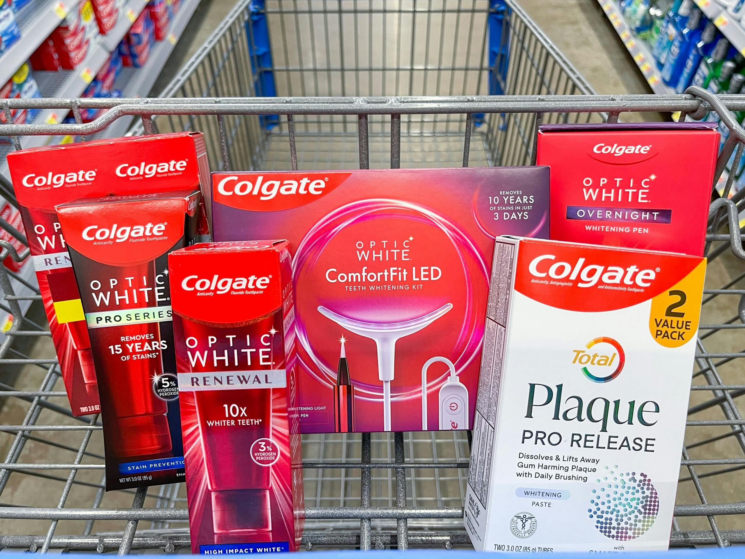 A variety of Colgate products sitting in a store cart.