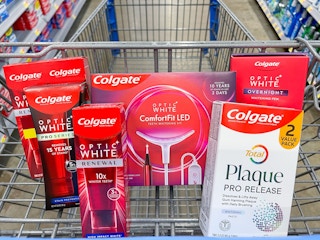 A variety of Colgate products sitting in a store cart.