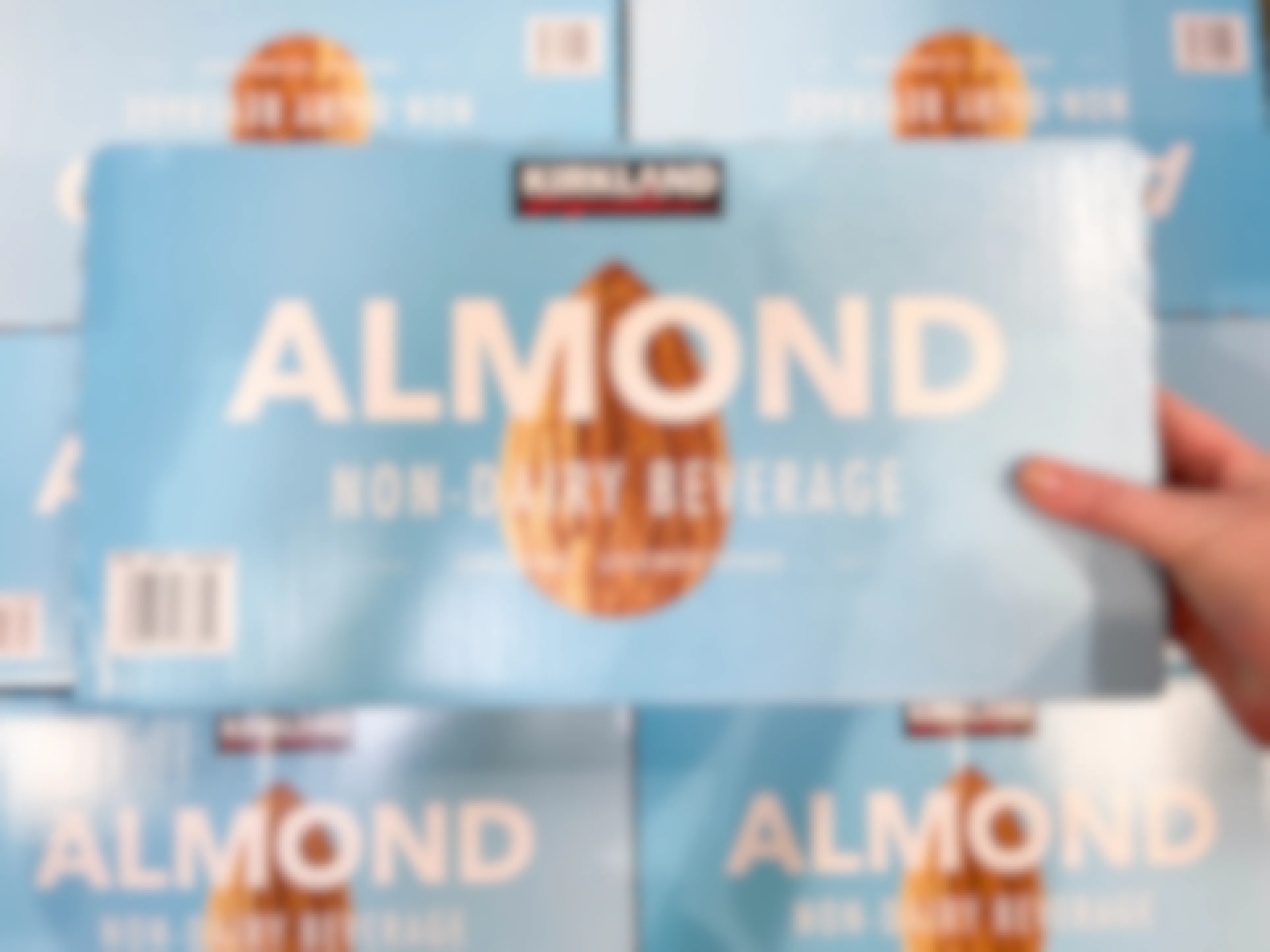 a box of almond milk being held in store