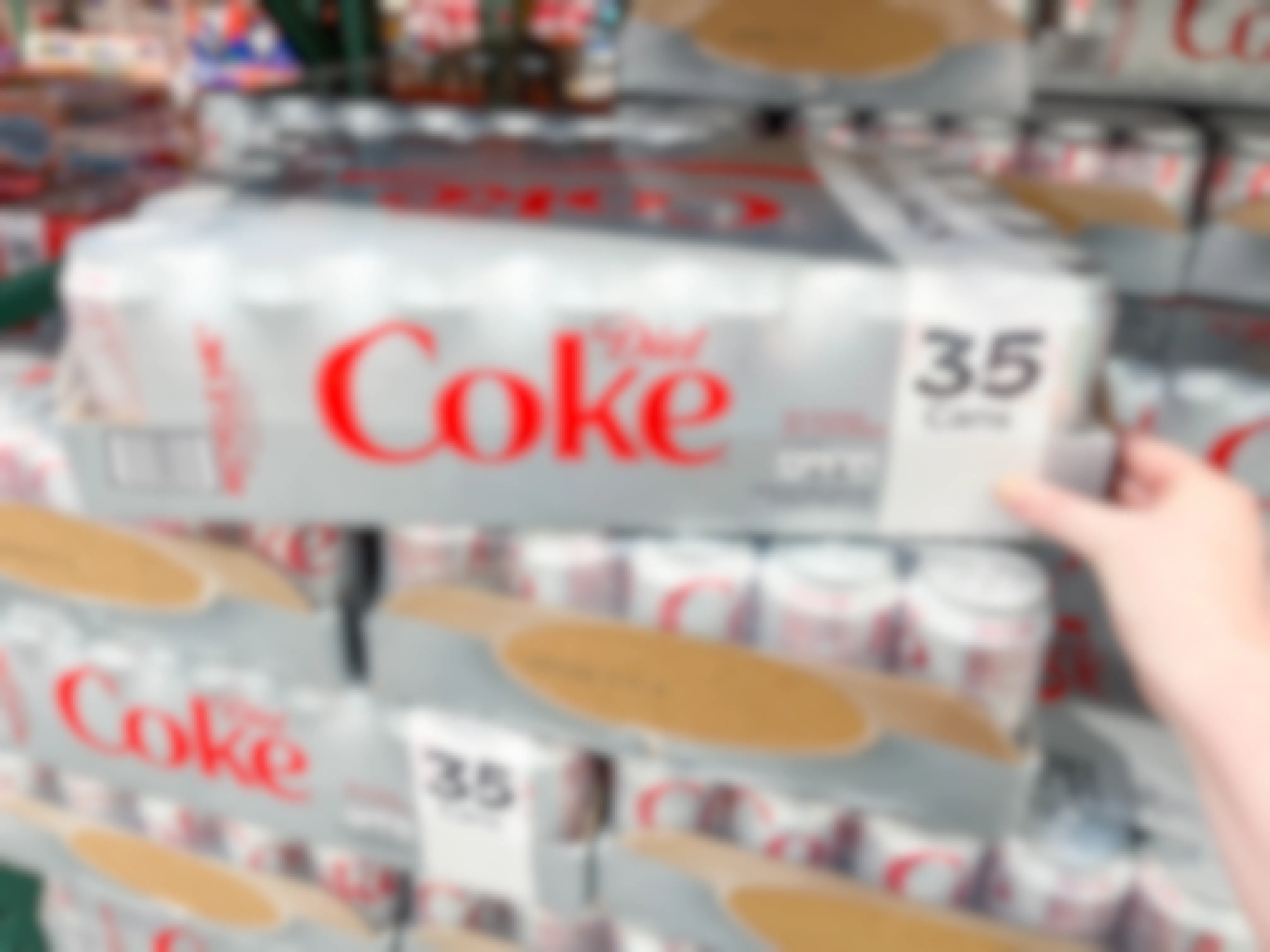 a box of diet coke being grabbed in store