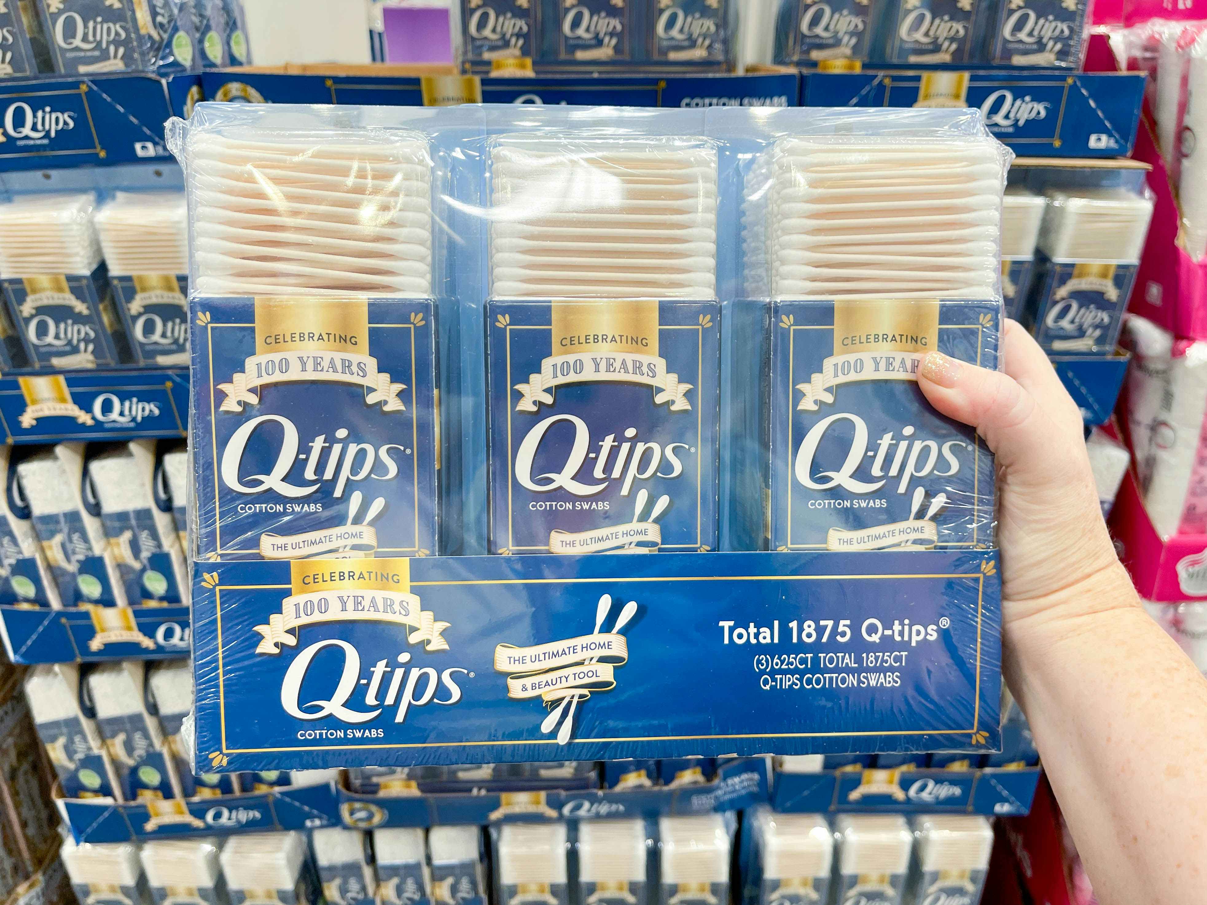 a package of qtips being held in store