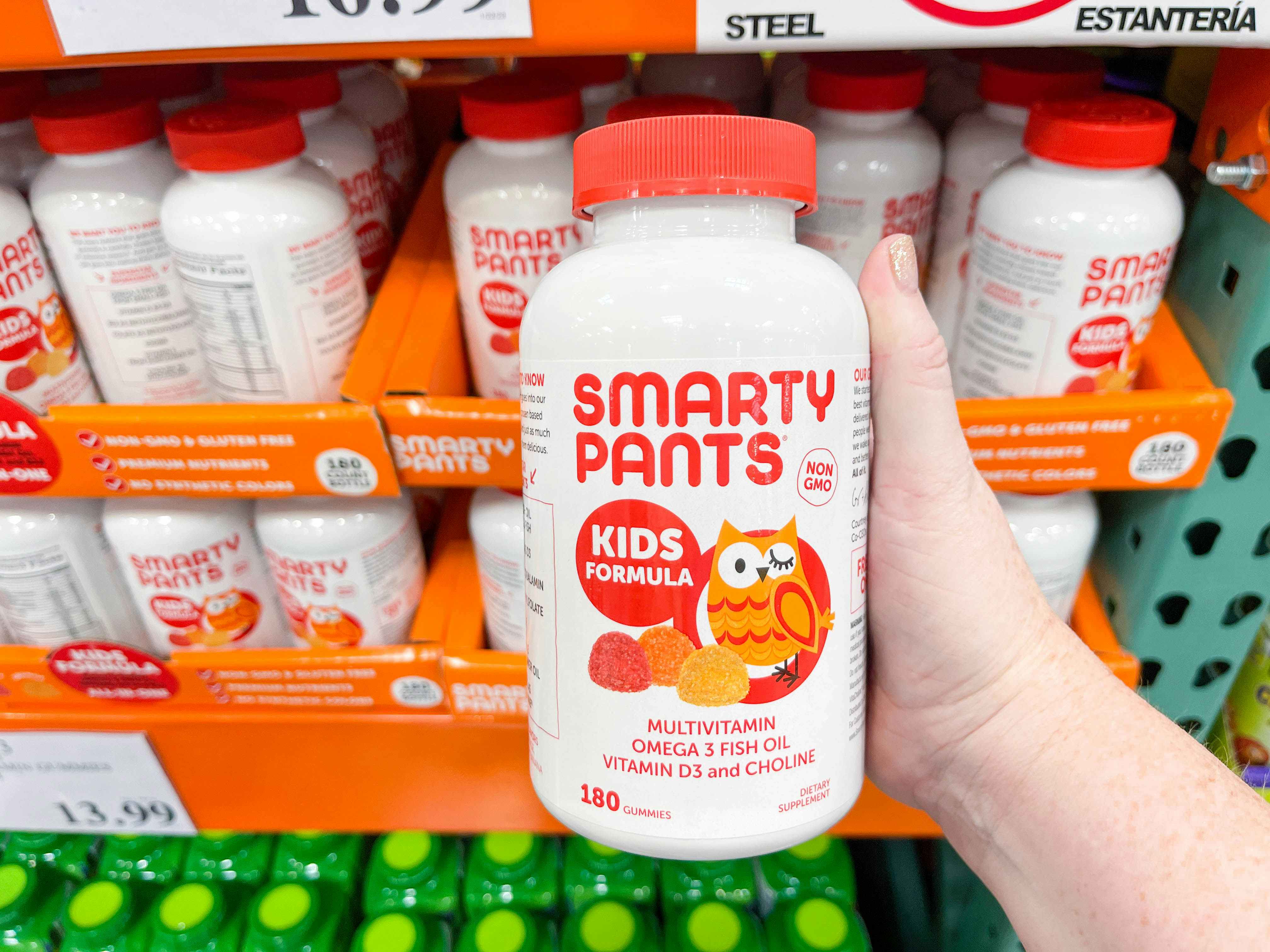 a bottle of smarty pants vitamins being held in store