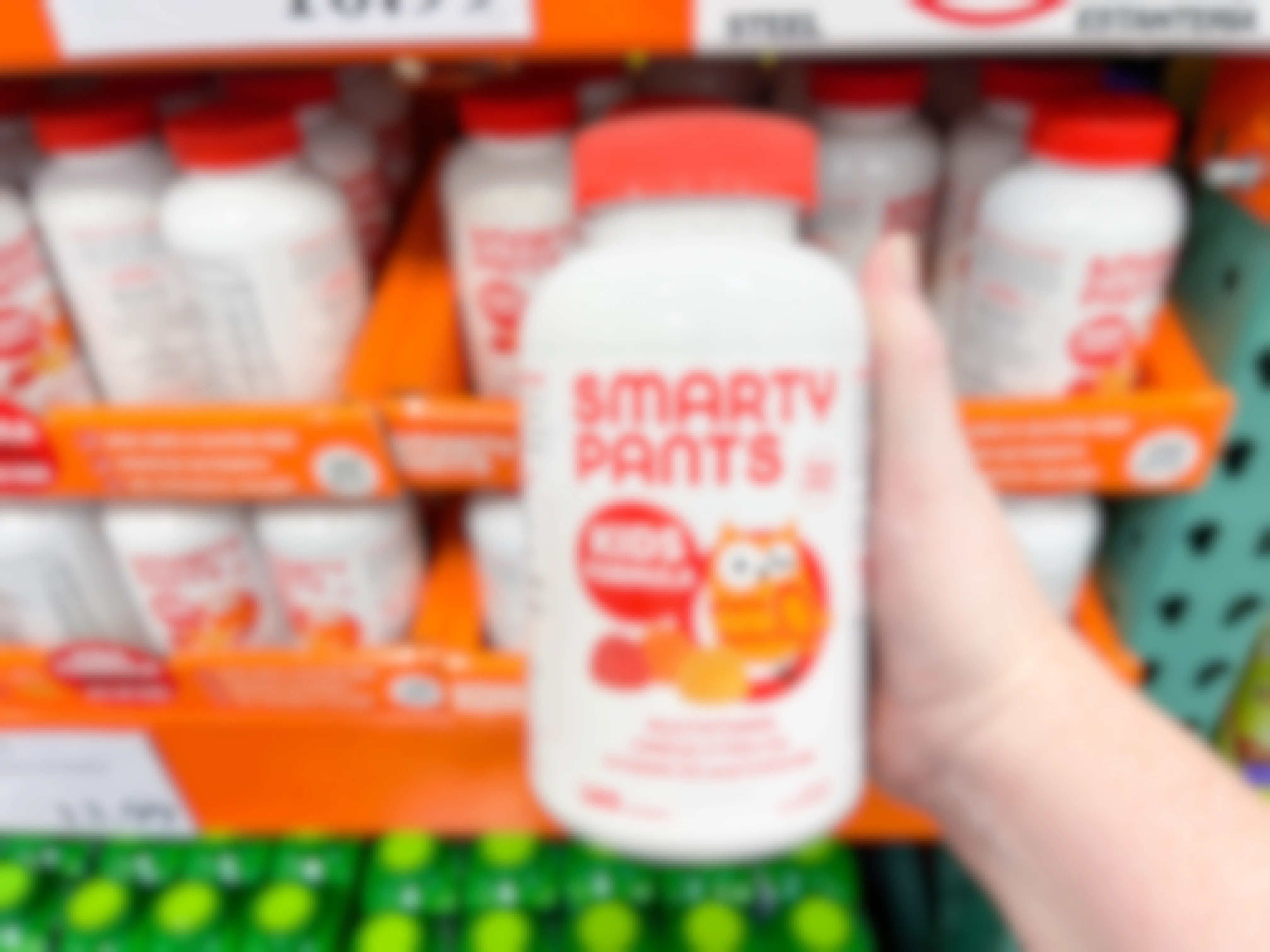 a bottle of smarty pants vitamins being held in store