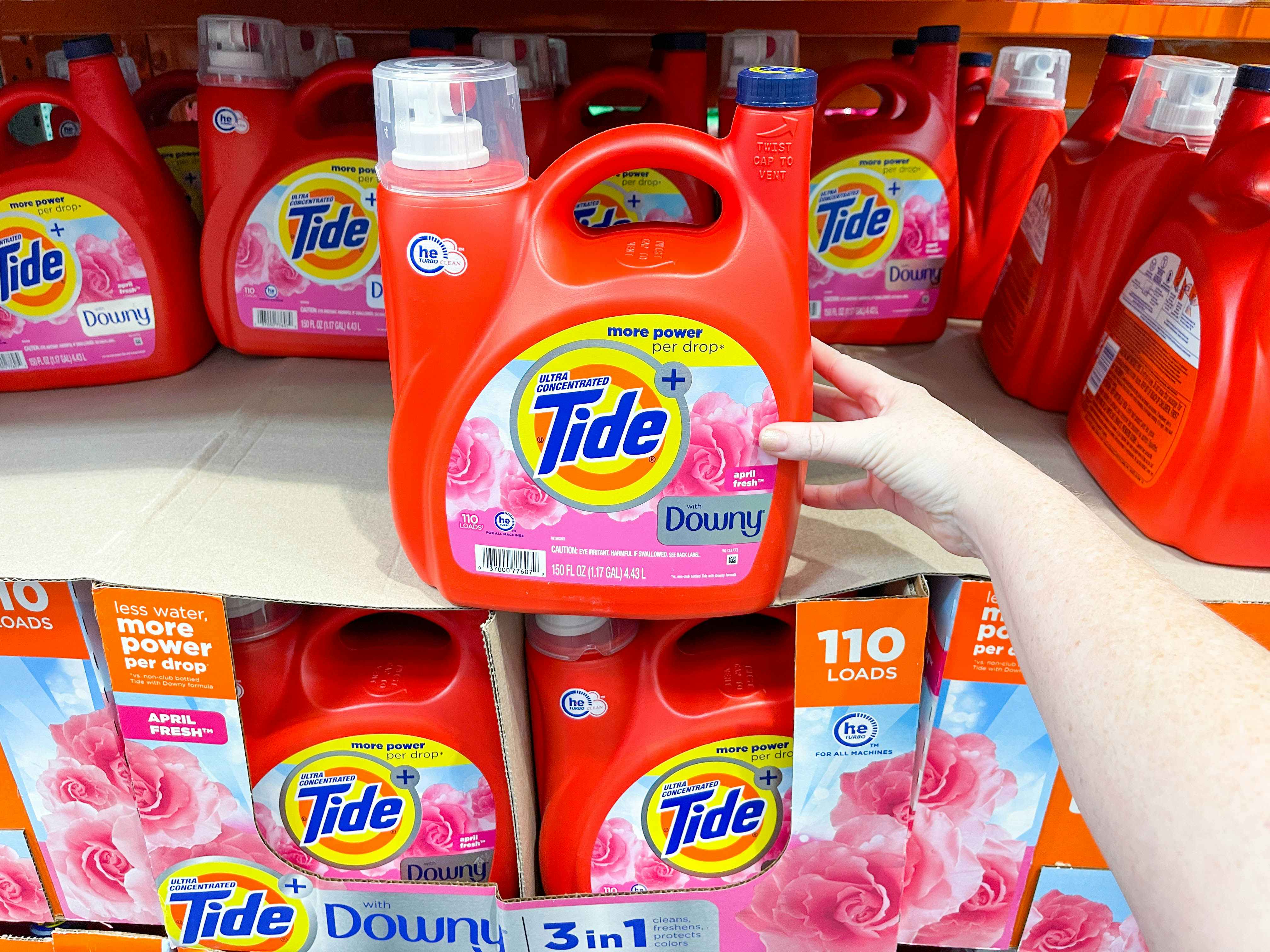 a large bottle of tide being held in store 