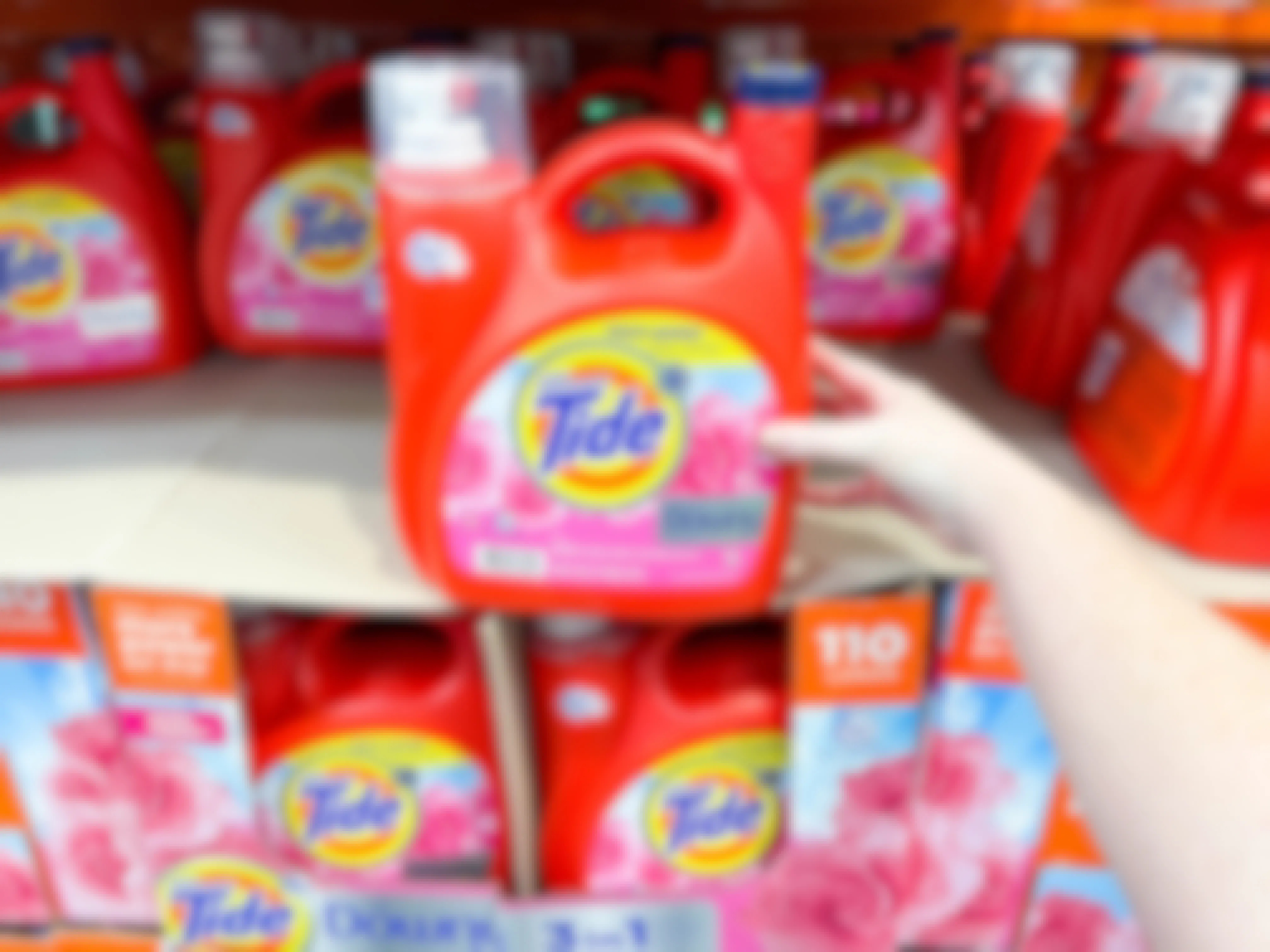 a large bottle of tide being held in store 