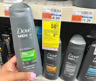 hand holding two bottles of Dove Men+Care 2in1 Shampoo and Conditioner next to sales tag