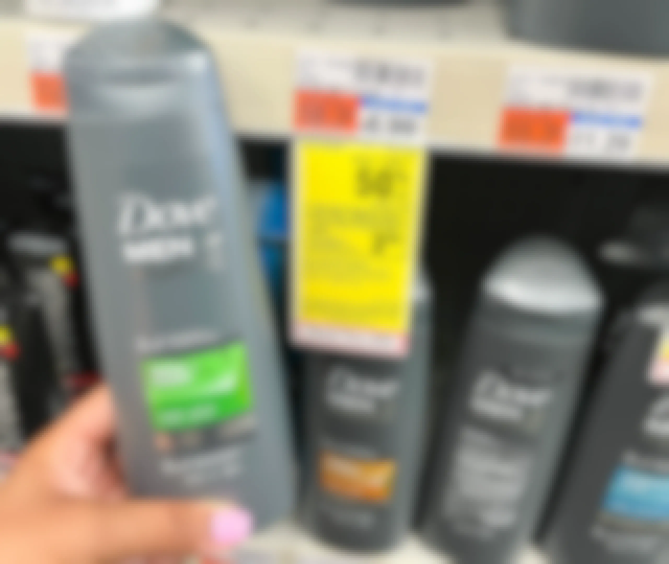 hand holding two bottles of Dove Men+Care 2in1 Shampoo and Conditioner next to sales tag