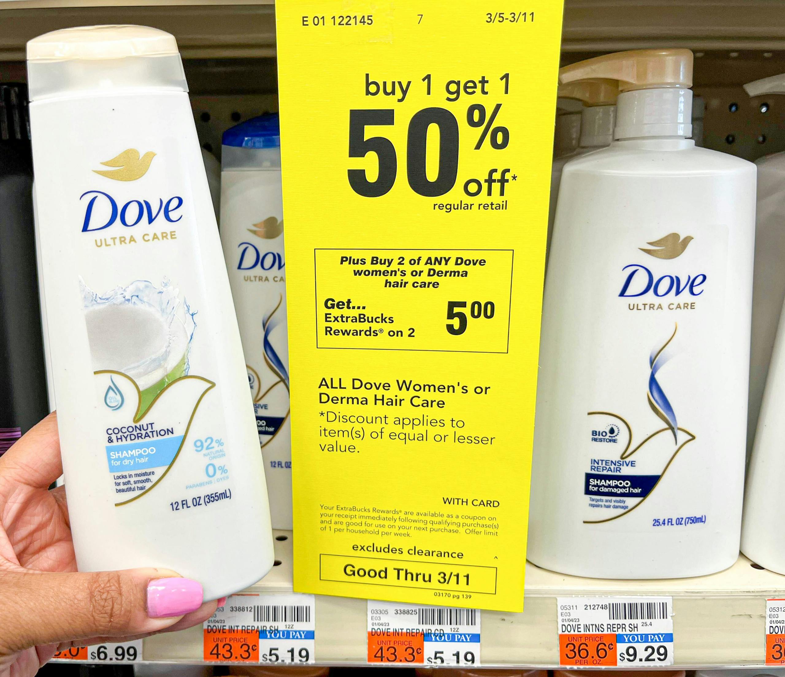 hand holding Dove shampoo next to sales tag