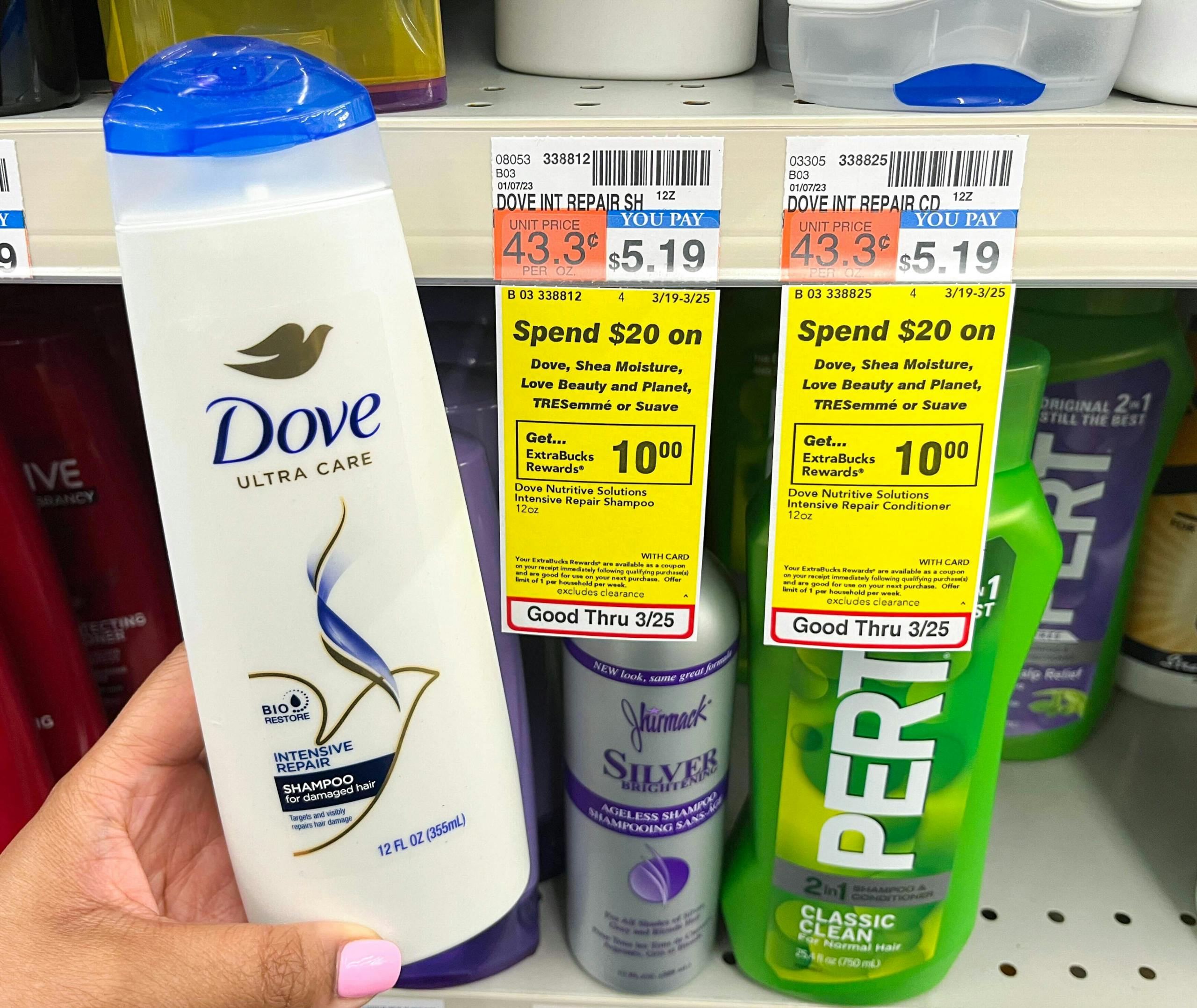 hand holding bottle of Dove shampoo next to sales tag