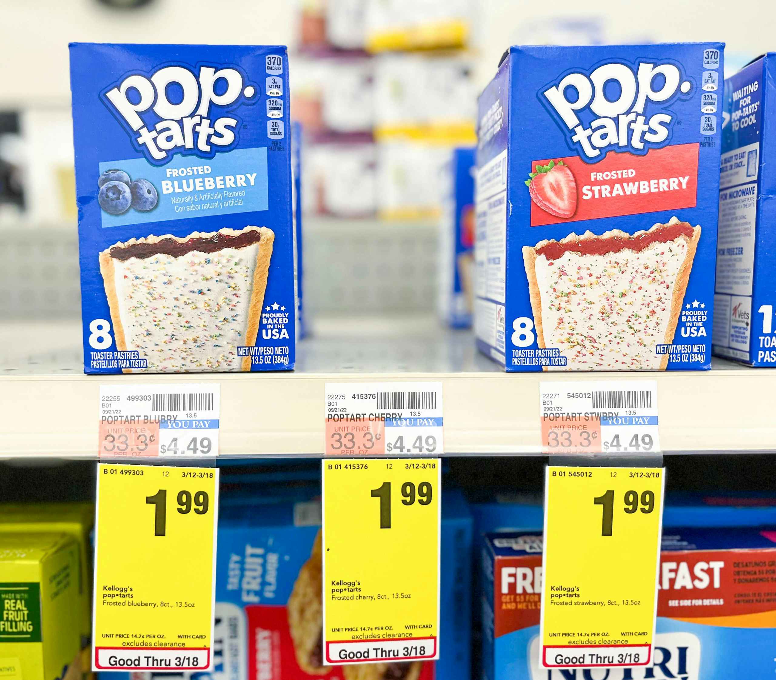 box of frosted blueberry and strawberry pop-tarts on shelf with sales tag underneath
