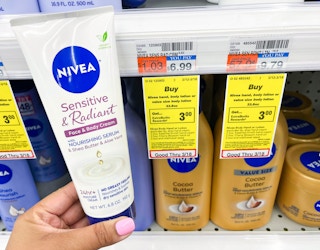 hand holding bottle of Nivea cream next to sales tag
