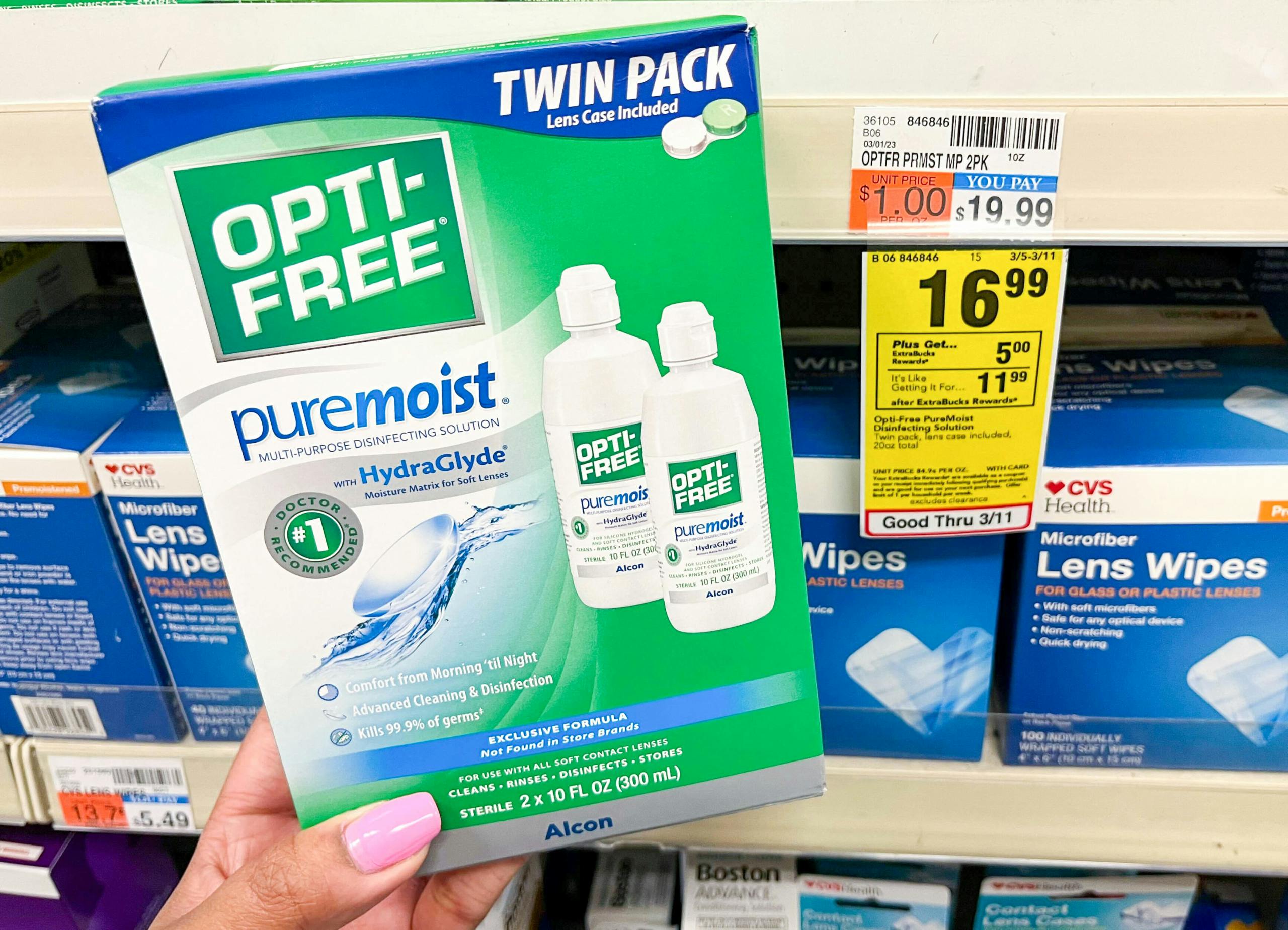 hand holding one box of opti-free pure moist solution next to sales tag