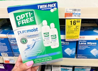 hand holding one box of opti-free pure moist solution next to sales tag
