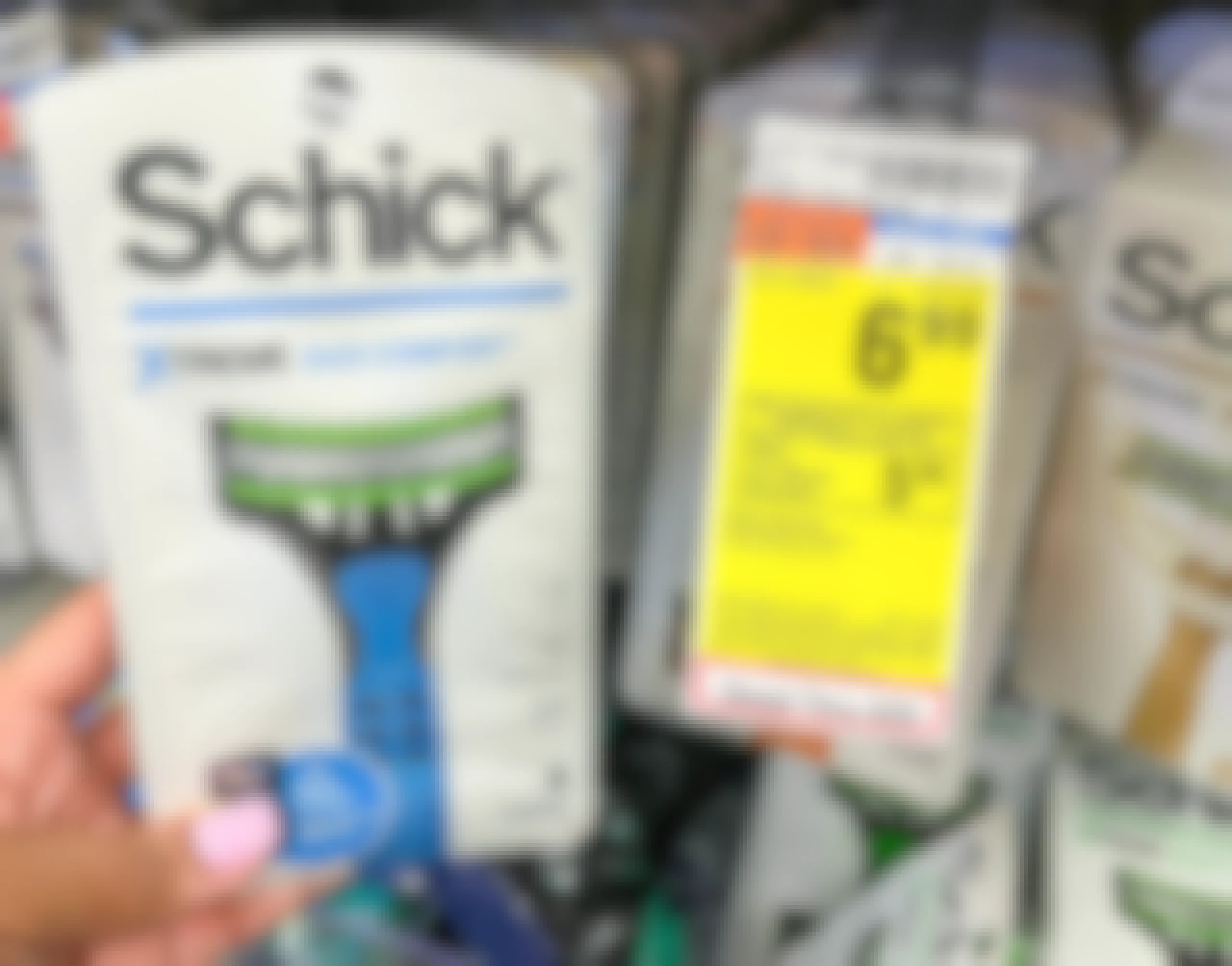 hand holding pack of Schick disposable razors next to sales tag