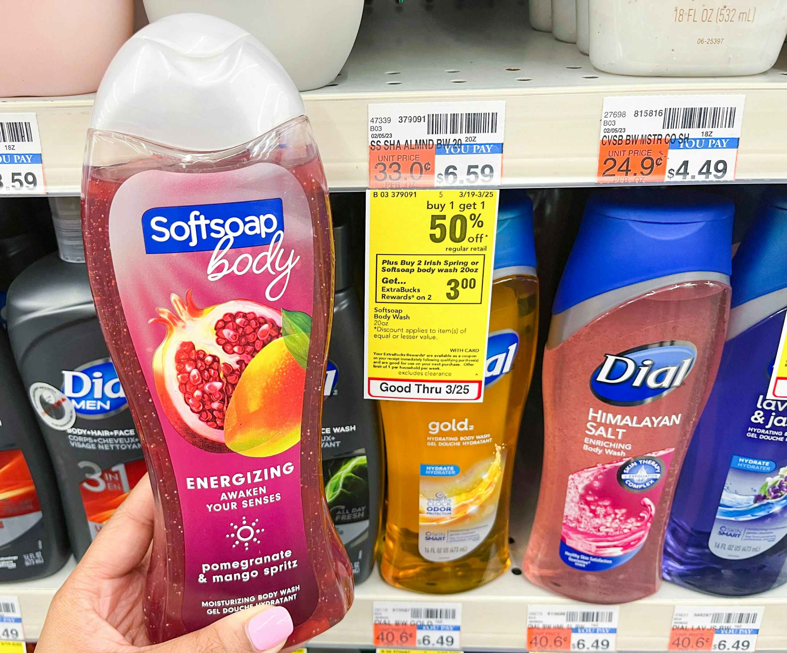 hand holding Softsoap body wash bottle next to sales tag