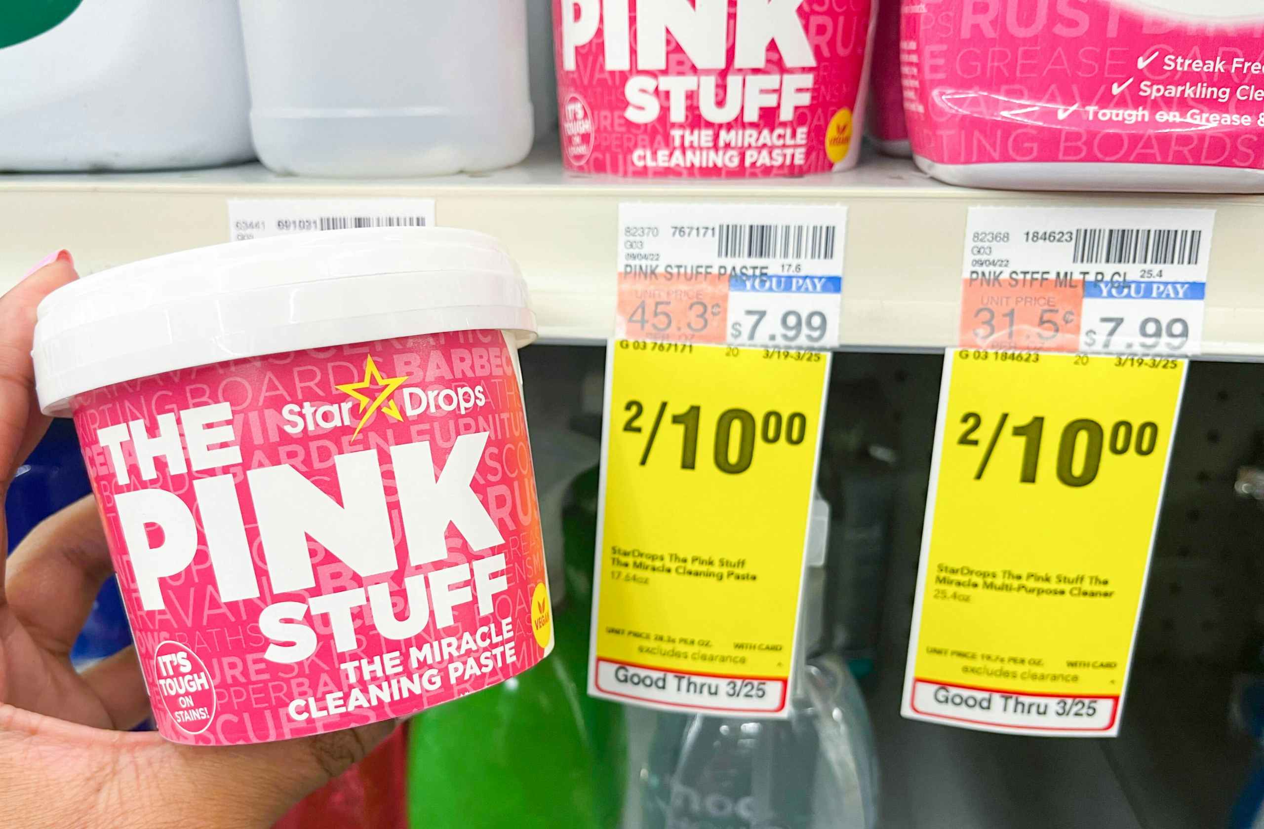hand holding The Pink Stuff paste next to sales tag