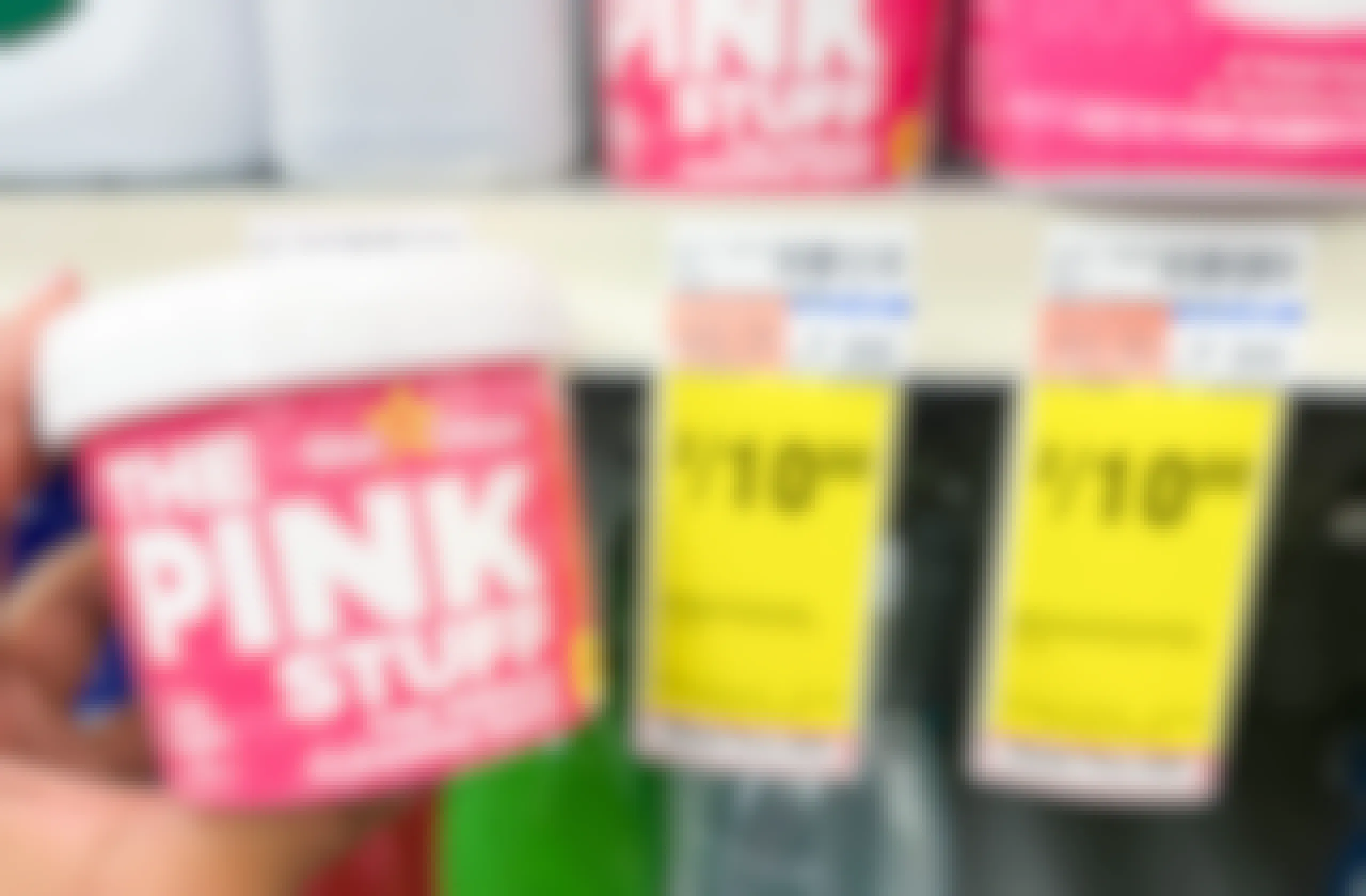 hand holding The Pink Stuff paste next to sales tag