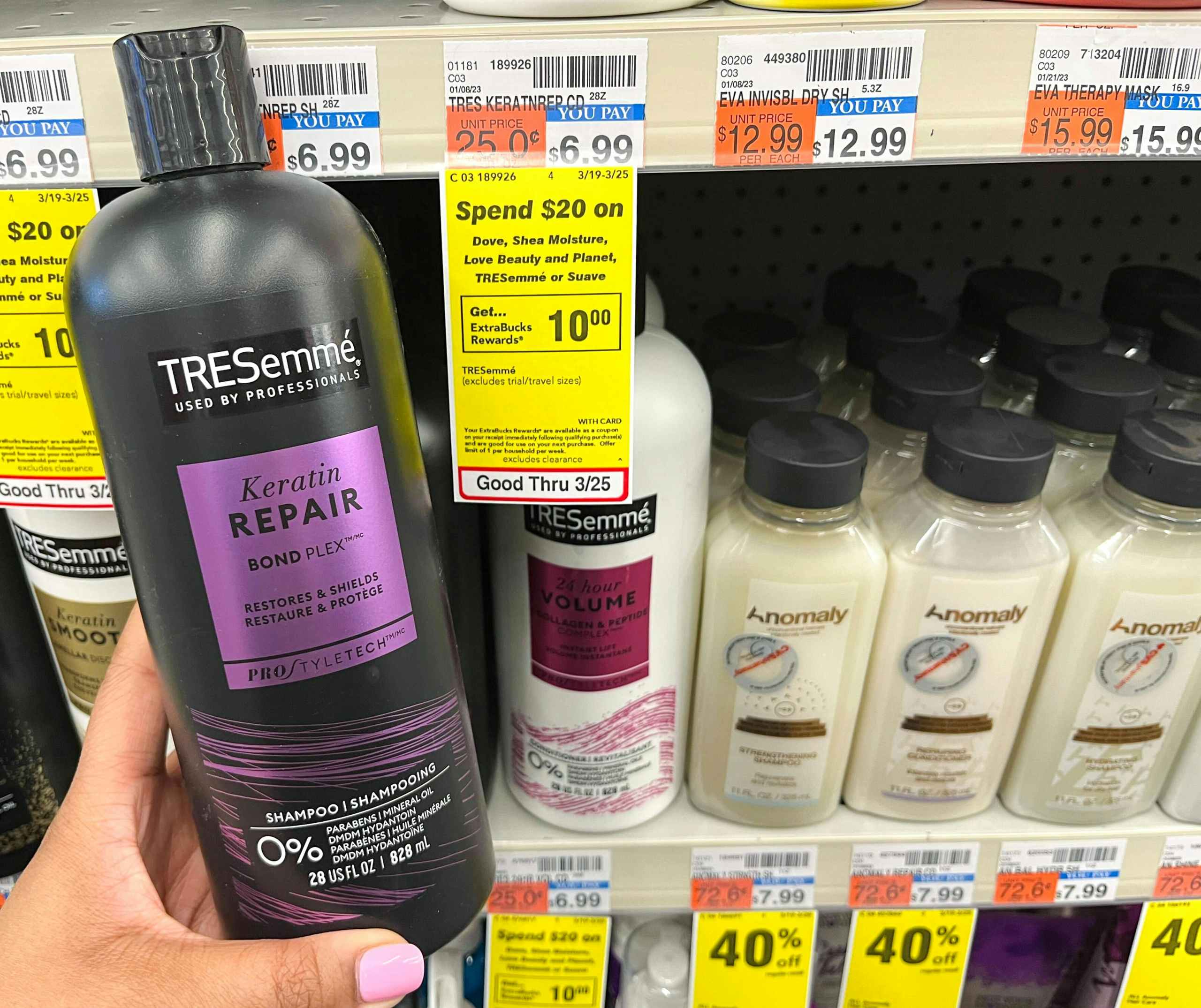 hand holding bottle of Tresemme shampoo next to sales tag