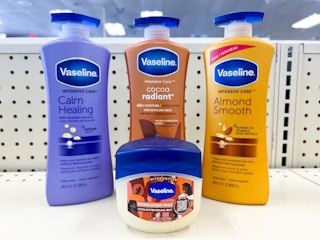 bottle of Vaseline next to three bottles of Vaseline lotions on shelf