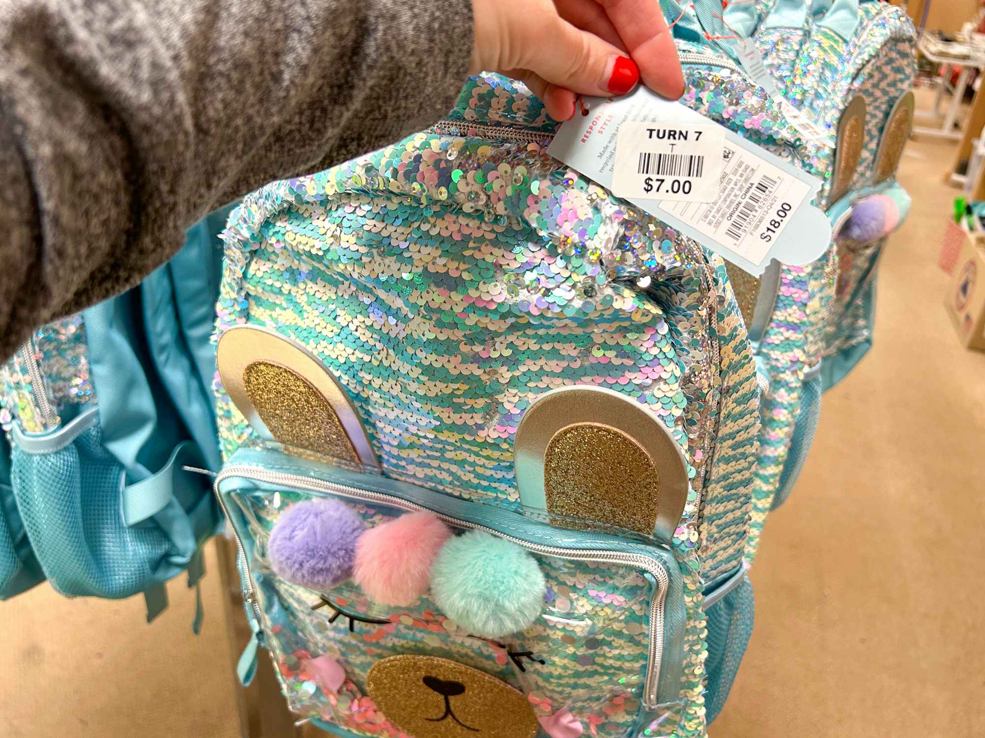 A sparkly Cat & Jack backpack with a price tag of $7 at Turn7