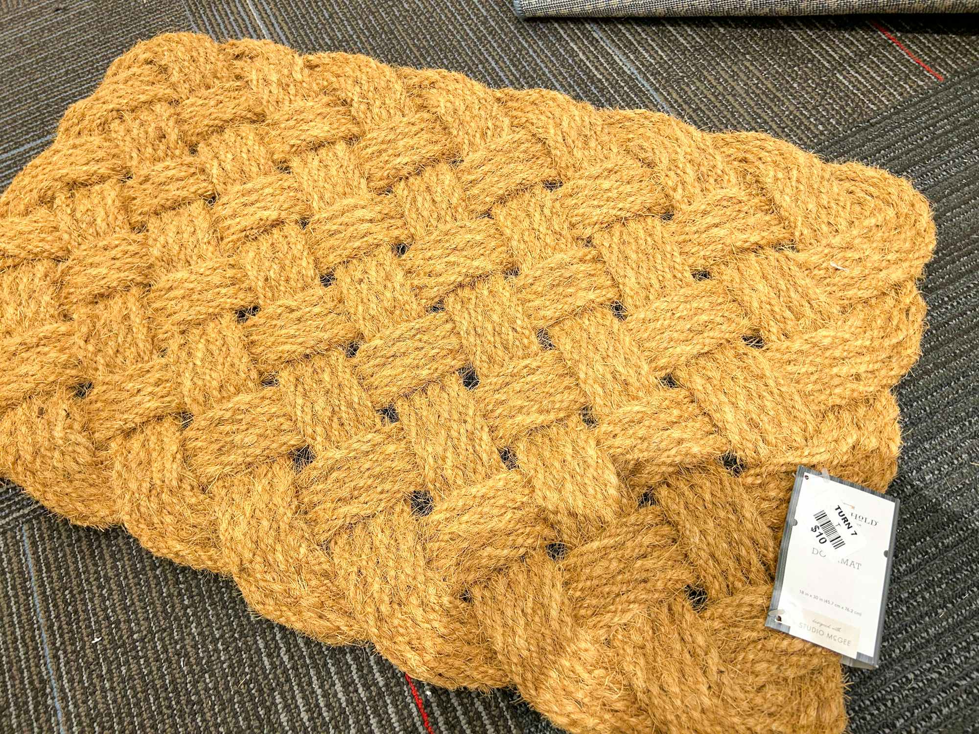 A Studio McGee rug on the floor in a Turn7 store