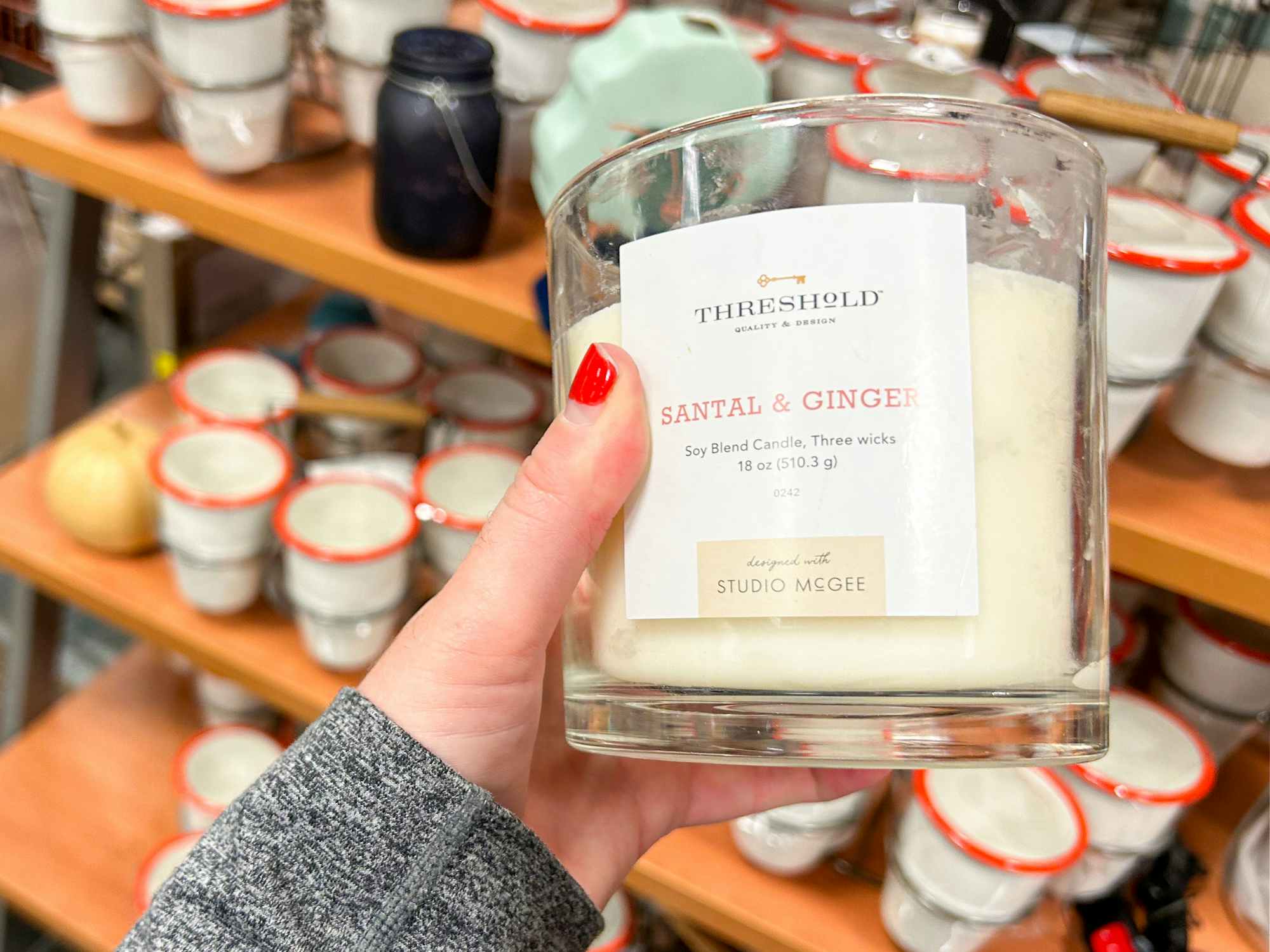 Someone holding a candle in a Turn7 store