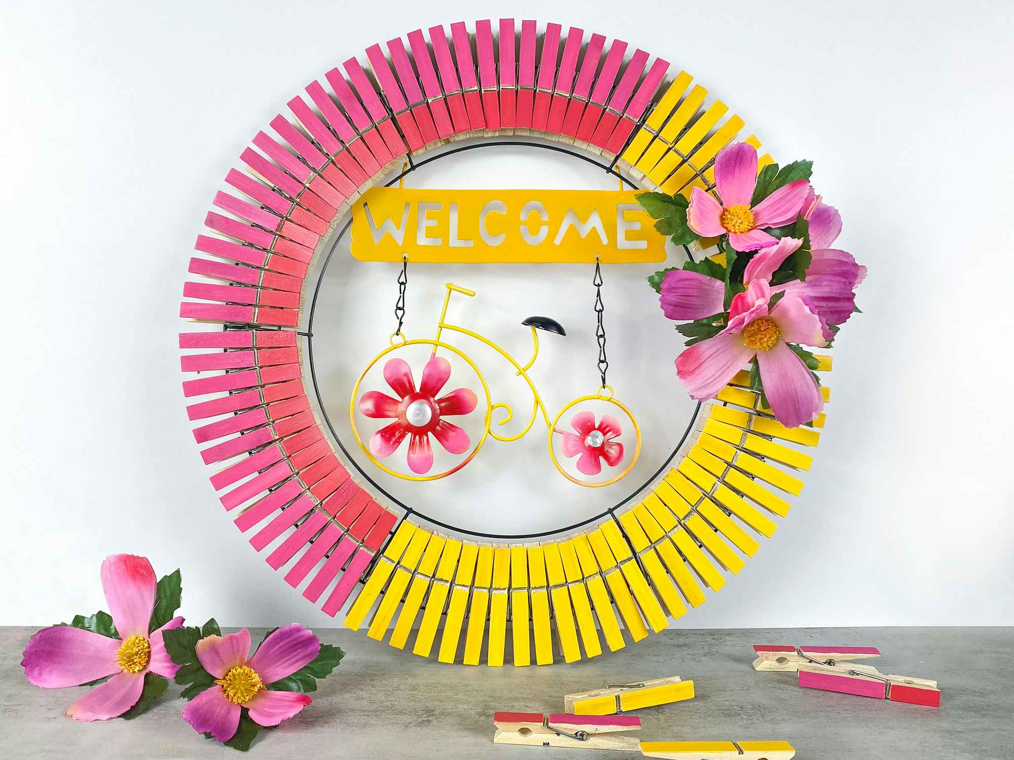 finished bright spring wreath with dollar tree garden sign and painted clothespins