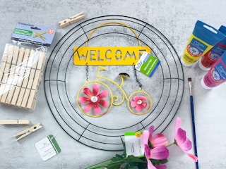 bright spring wreath with dollar tree garden sign and painted clothespins