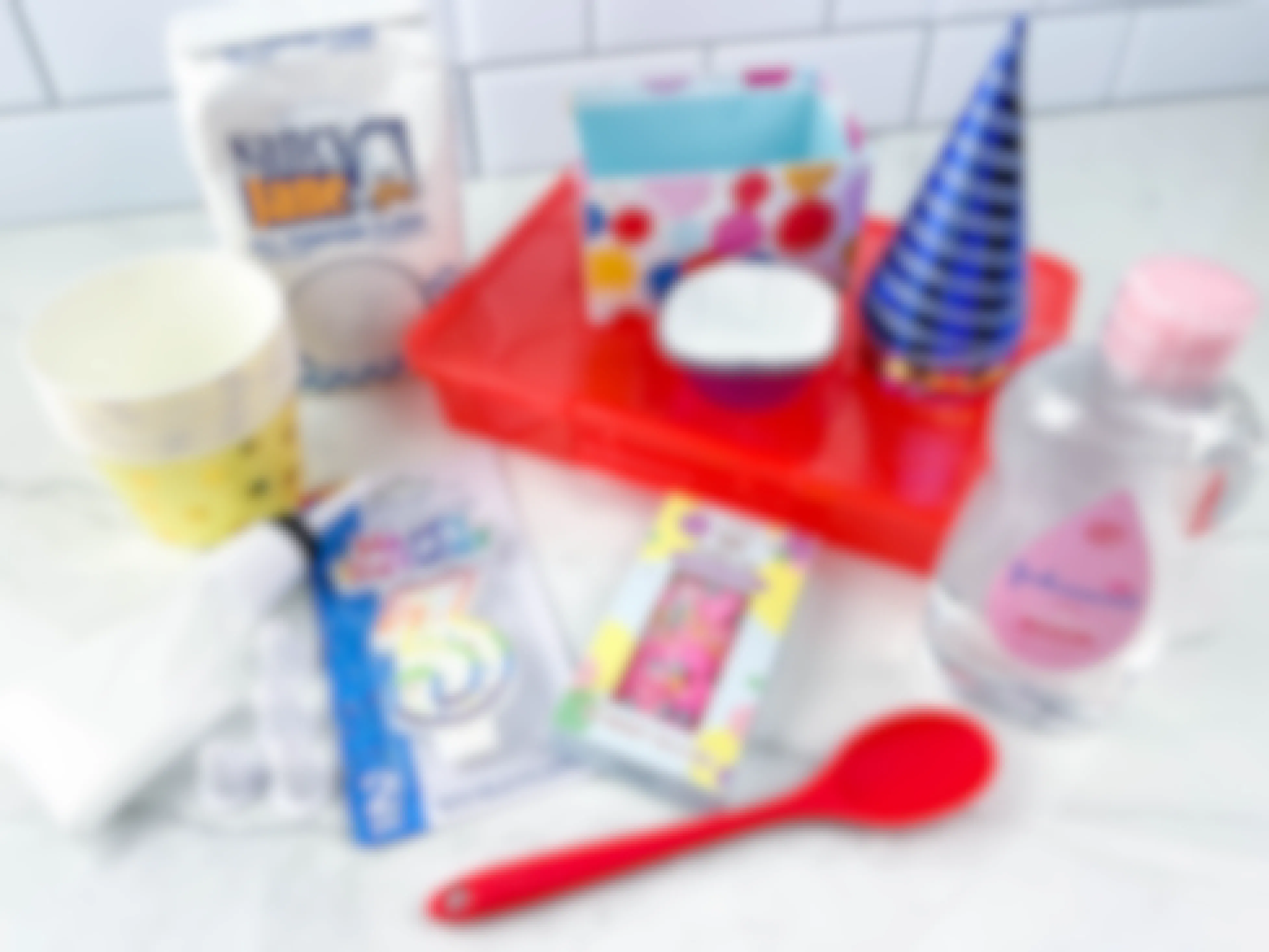 items to make a diy birthday party sensory bin sitting on a counter