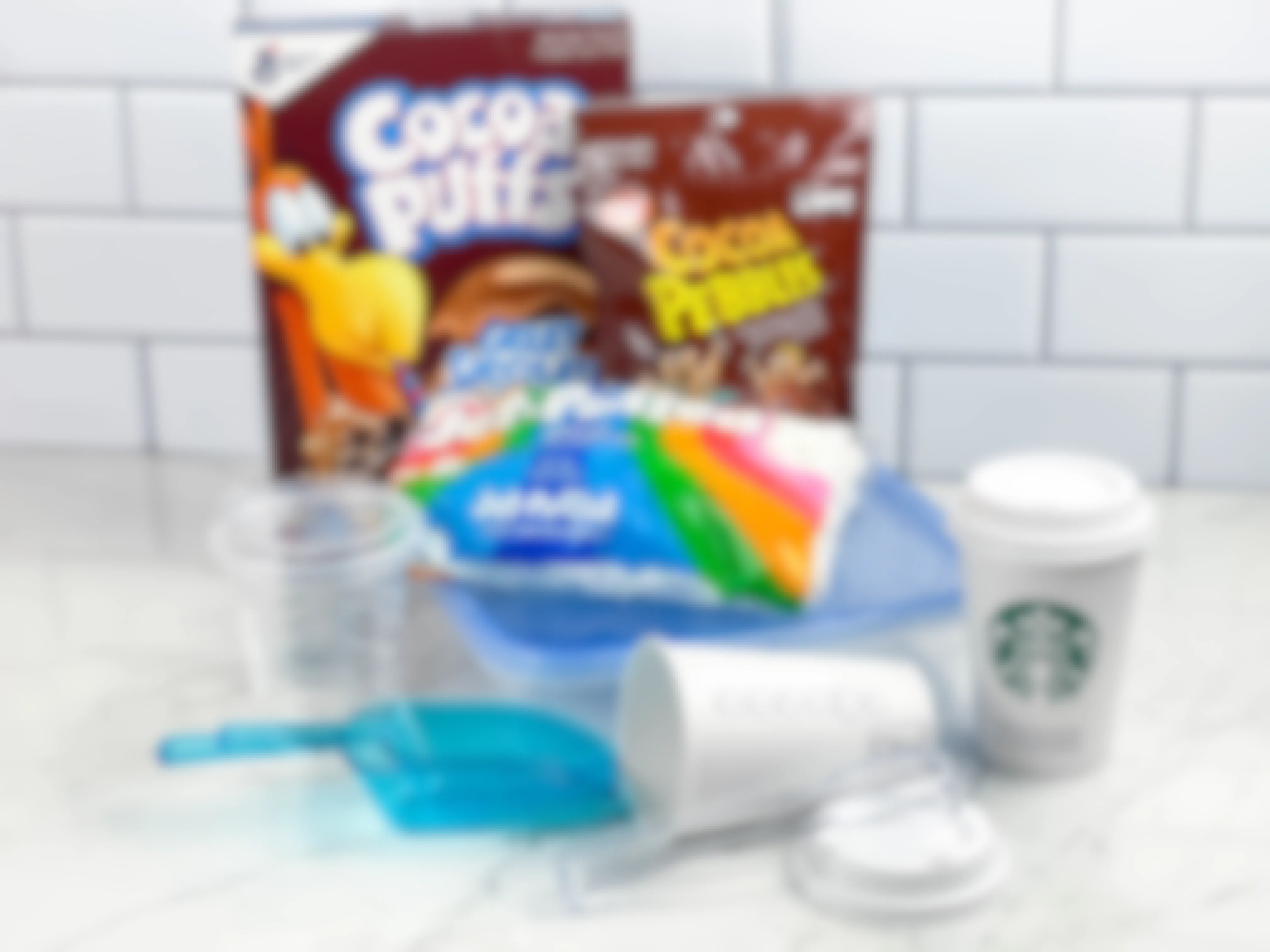 items to make a diy coffee shop party sensory bin sitting on a counter